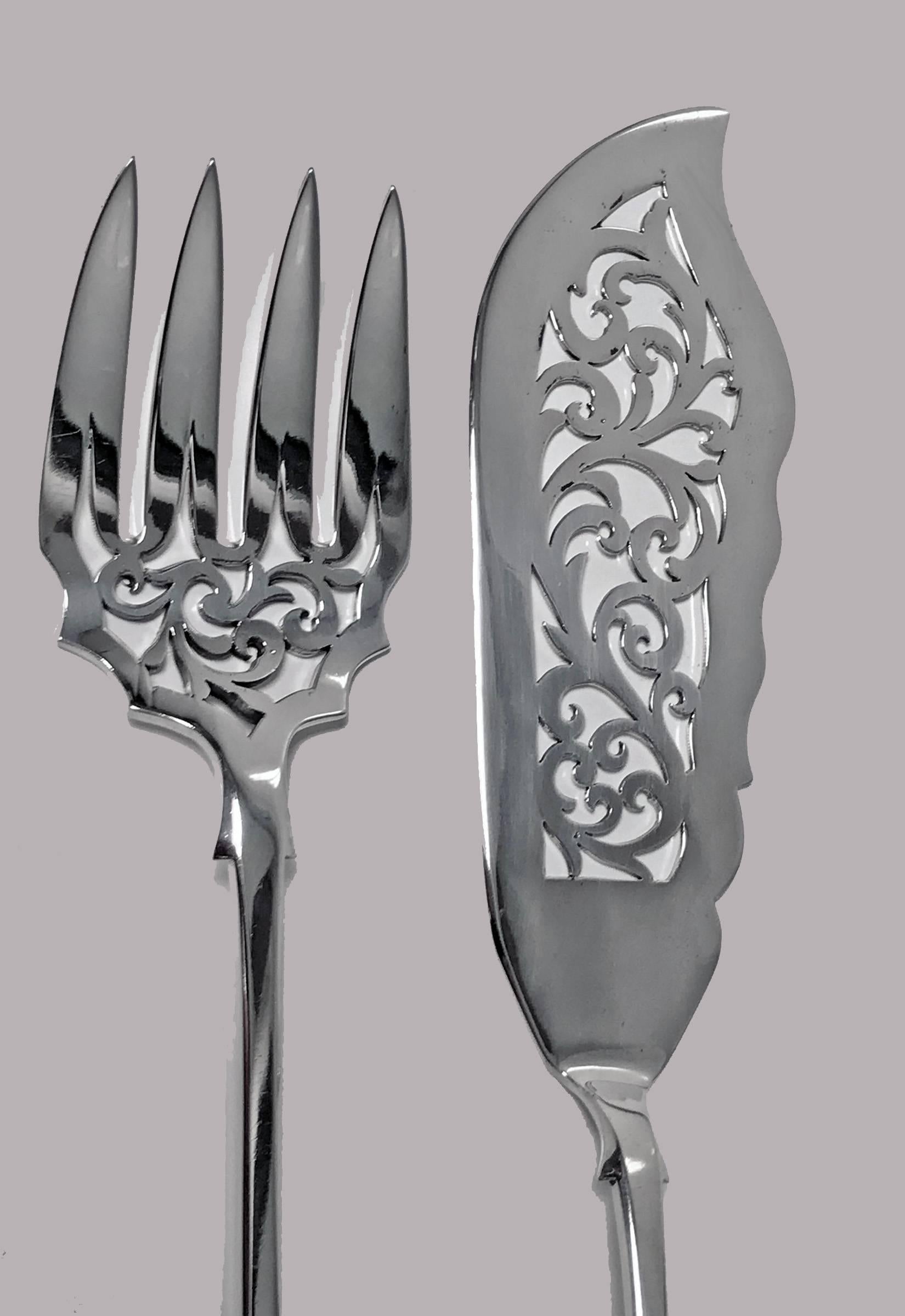 Pair of antique Victorian silver fish Servers, London 1854, Charles Boyton. Pierced foliate design blade and tines, plain fiddle handles. Lengths: - Fork- 9.75 inches. Knife: - 12.25 inches. Total weight: 234.36 grams.
 