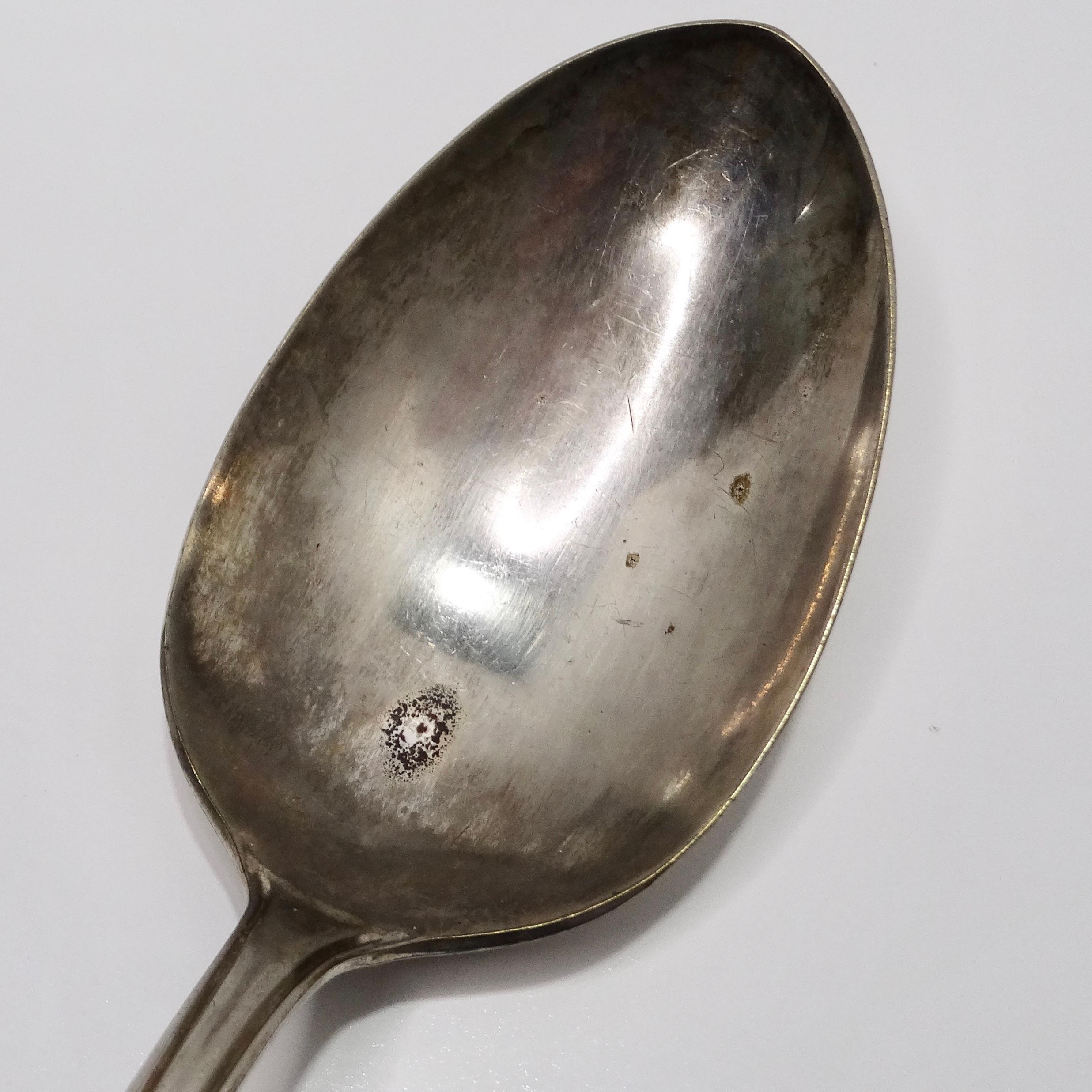 Introducing the Antique Sterling Silver Shell Spoon, a captivating piece from the early 1900s that exudes timeless elegance and sophistication.

Crafted from pure sterling silver, this exquisite spoon features a delicate white shell motif at the