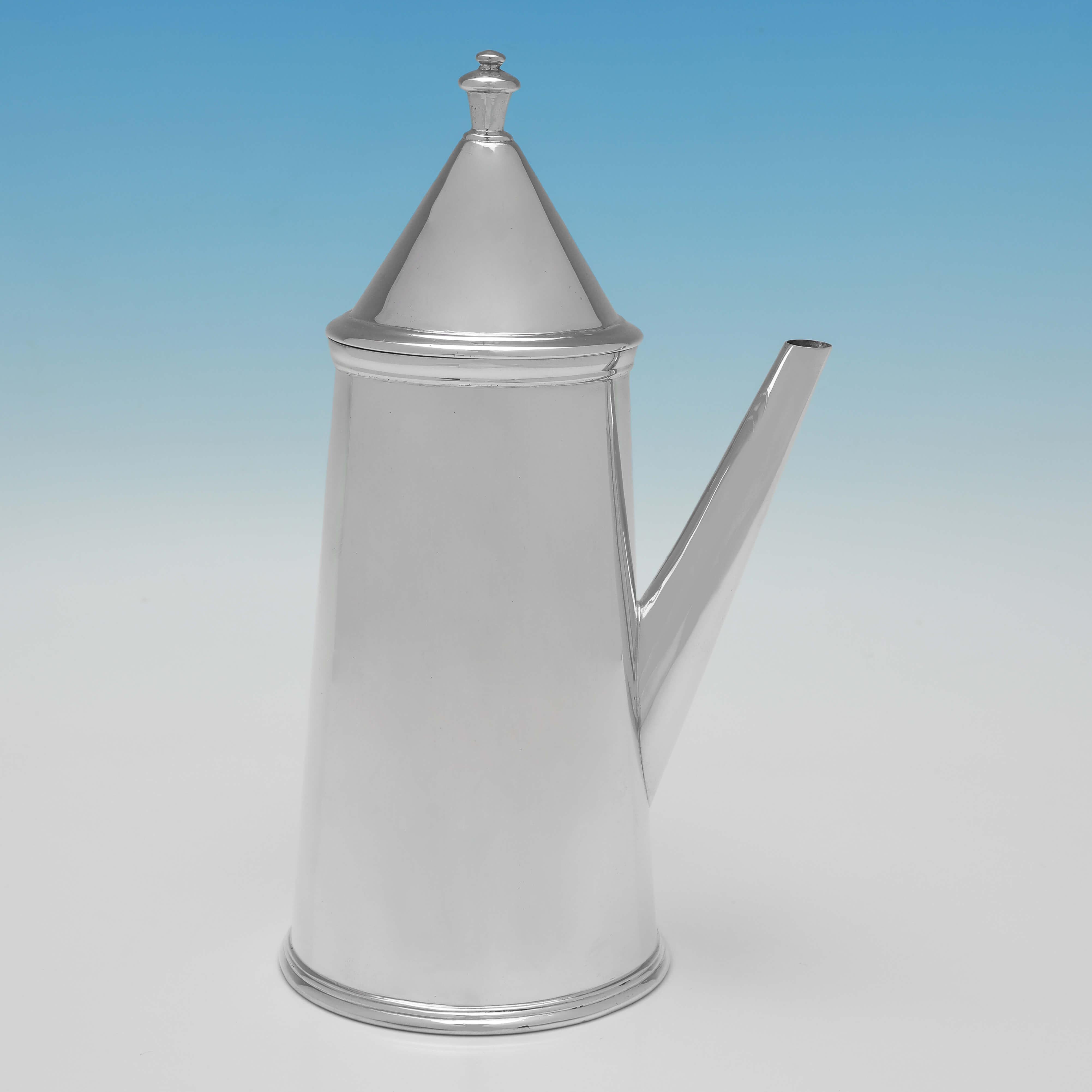 Hallmarked in Chester in 1913 by Nathan & Hayes, this handsome, Antique Sterling Silver Coffee Pot, features a wooden side handle, and a conical lid. 

The coffee pot measures 8.25