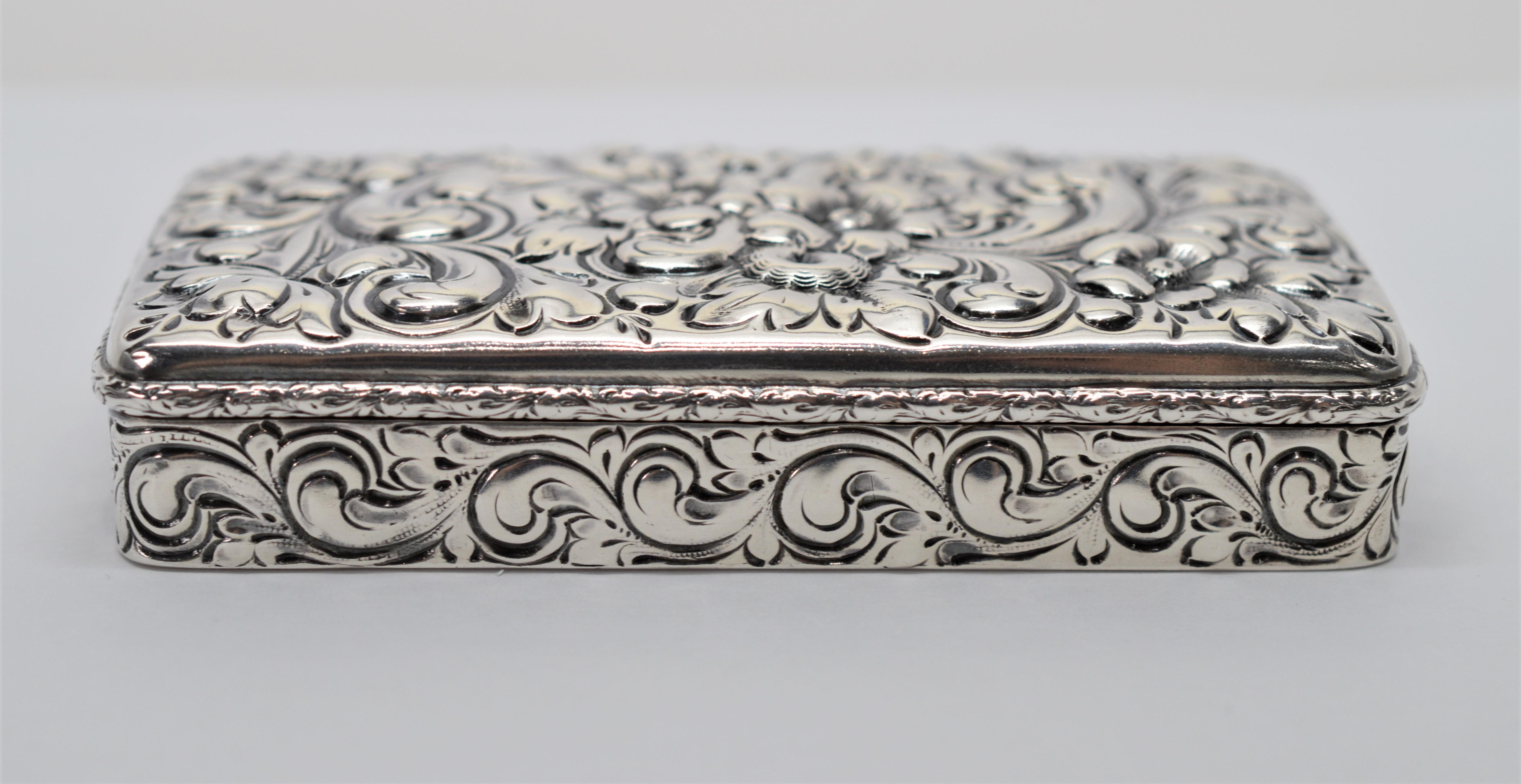 Fine Sterling Silver with American hallmarks, this antique snuff or tobacco box is beautifully created in the Nouveau style. The box measures 4 inches long x 2 inches wide and 7/8 inch deep. The hinged runs the full length of the box and with snap