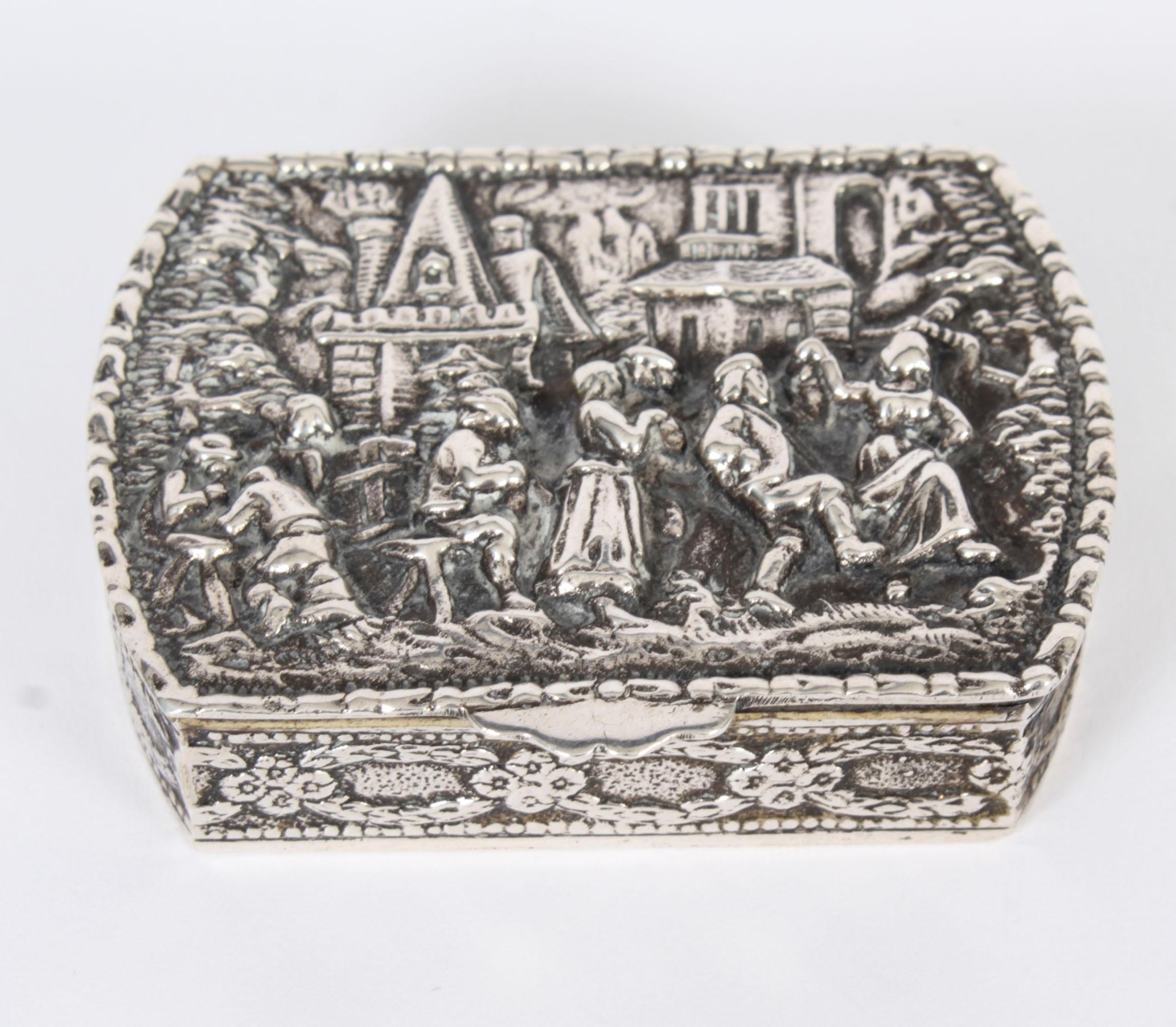 This is a wonderful heavy set antique Spanish sterling silver pill / snuff box,  bearing the Spanish 5 pointed star for sterling silver with makers mark Ucc, Circa 1900 in date.

It is decorated with repousse figural scenes of drinking and dancing.

