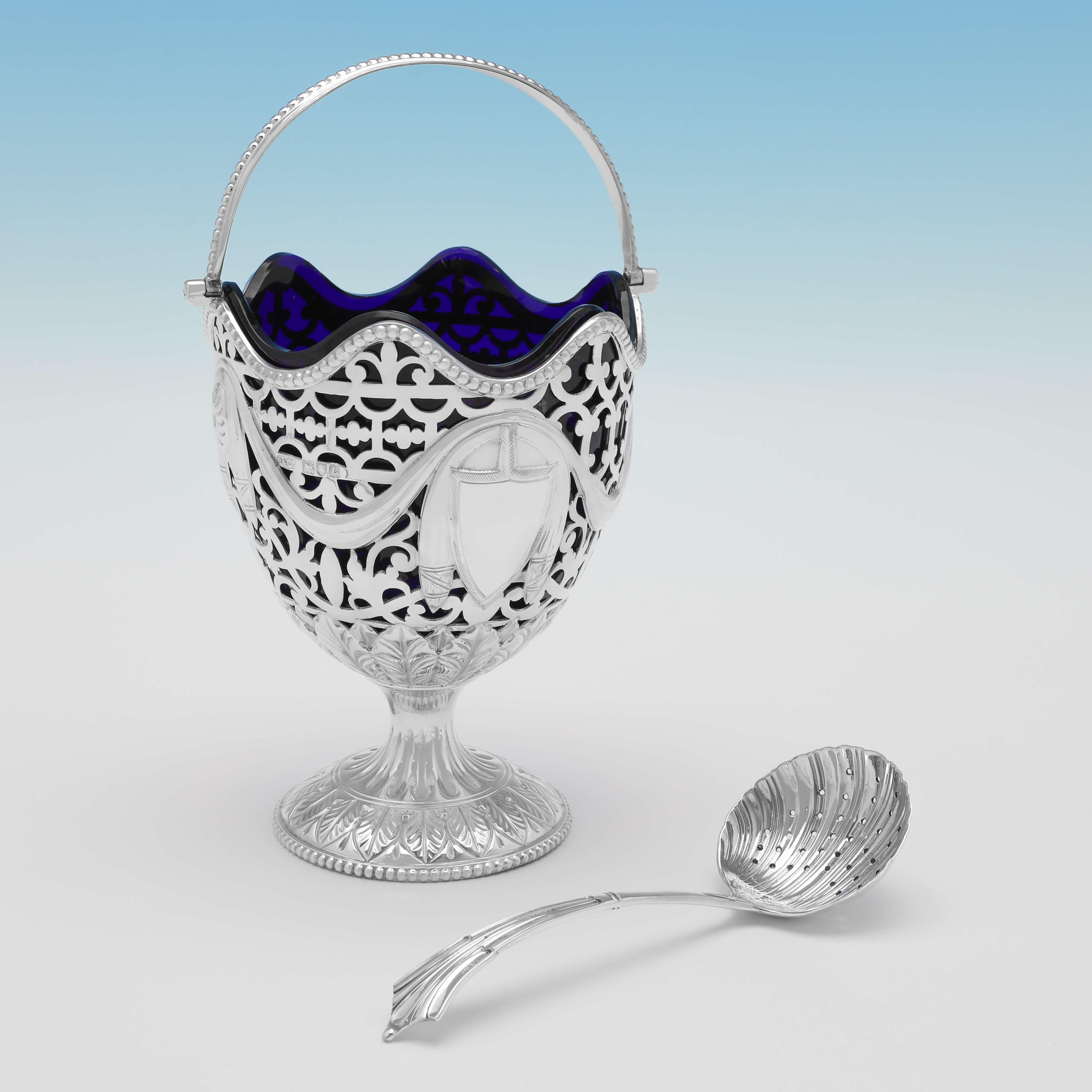 Hallmarked in London in 1914 by skinner & co. (the spoon by George Guirren Rhoden, sheffield 1910), this charming, antique sterling silver sugar basket & spoon, is presented in a box, and has the original blue glass liner. The sugar basket measures