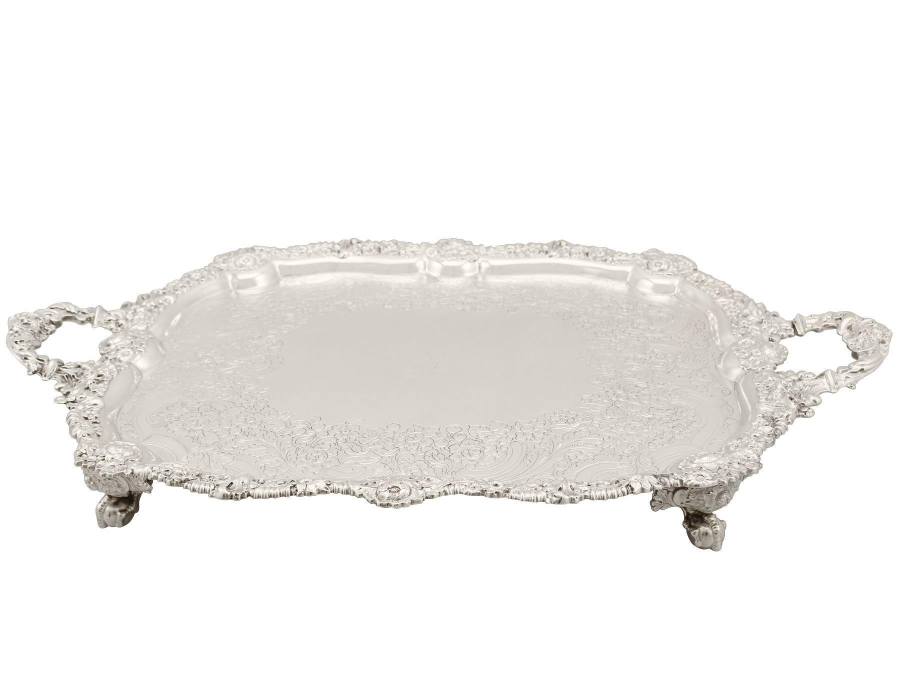 A magnificent, fine and impressive antique George IV English sterling silver tea tray, an addition to our range of silver trays, salvers and plates.

This magnificent antique George IV sterling silver tea tray has a rectangular shaped form with