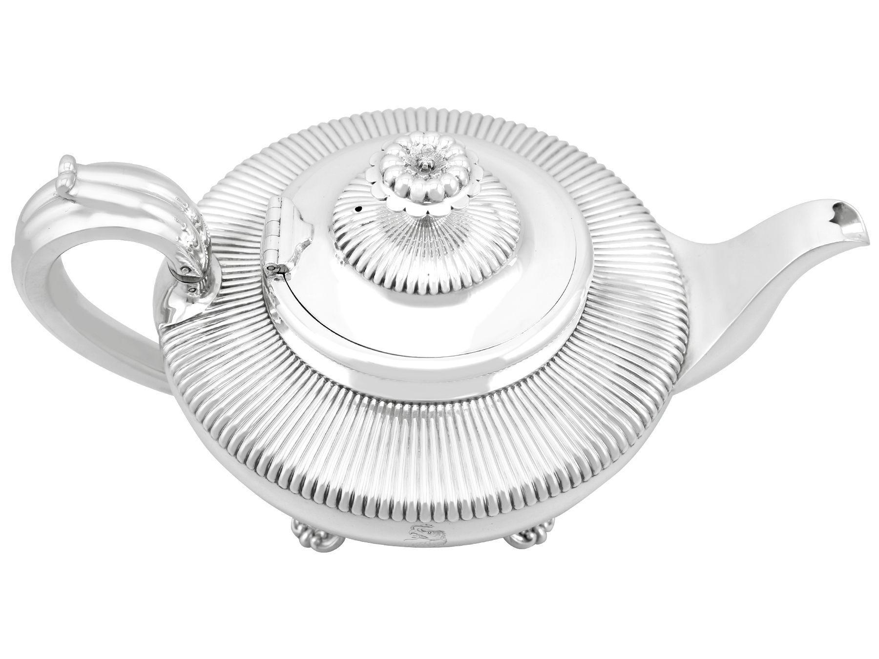 An exceptional, fine and impressive antique William IV English sterling silver teapot; an addition to our silver teaware collection.

This impressive antique silver teapot, in sterling standard, has a circular rounded form.

The upper portion of the