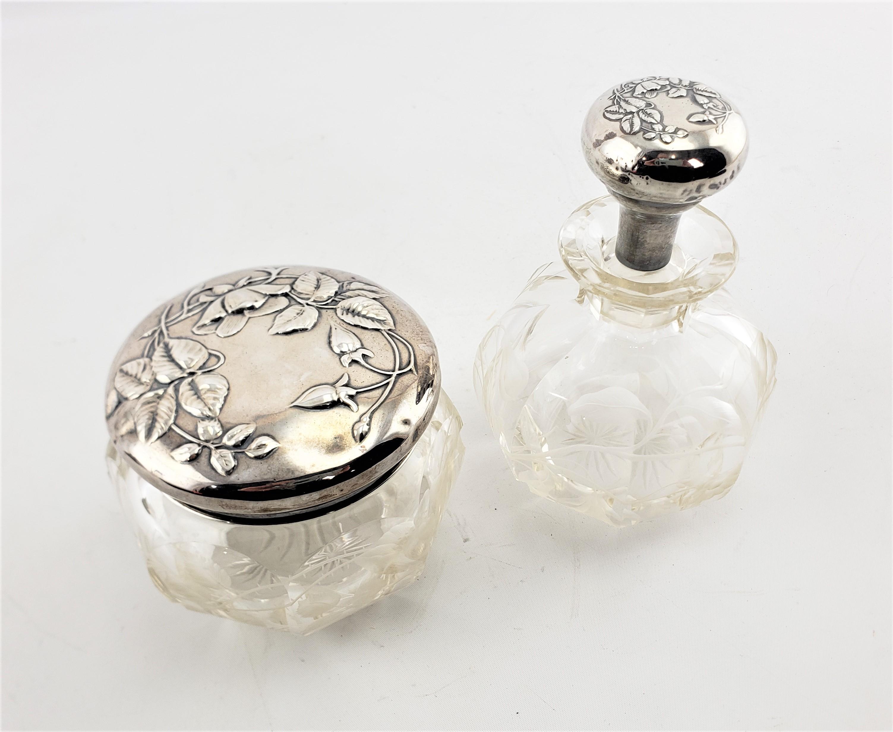 This antique sterling silver and etched crystal powder jar and scent bottle are hallmarked by an unknown maker, but presumed to have originated from England and dating to 1880 and done in the period Victorian style. The tops of this partial dresser