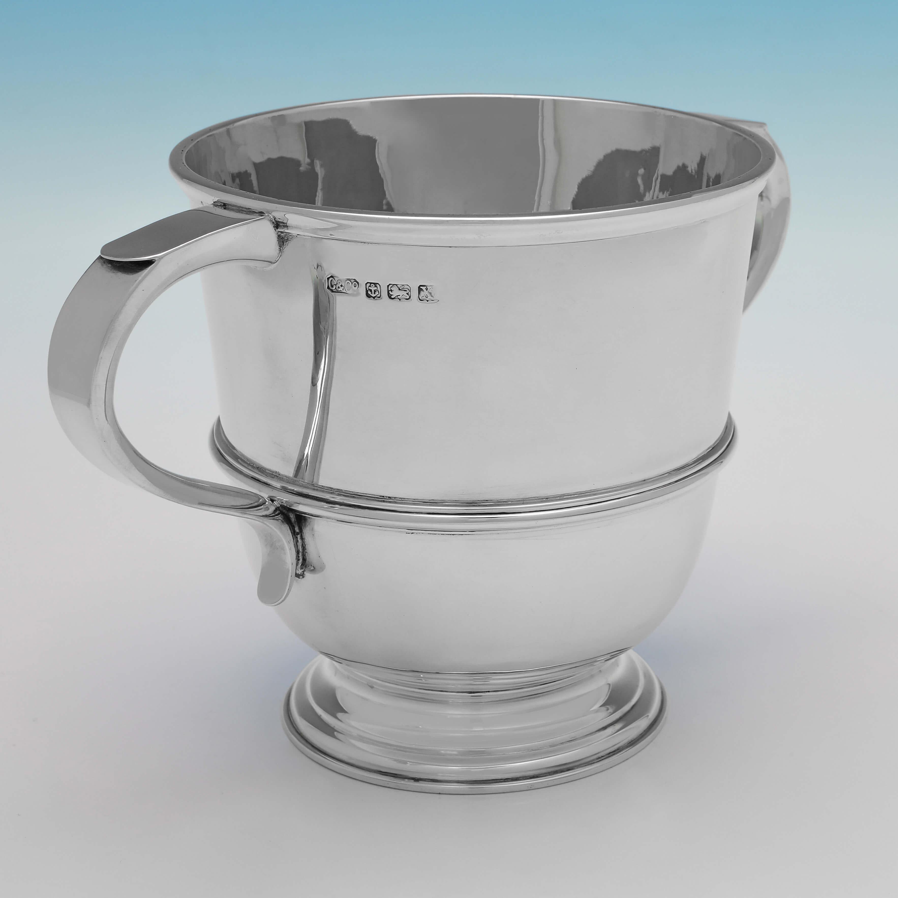 Hallmarked in London in 1922 by Carrington & Co., this handsome, Antique Sterling Silver Trophy Cup, is plain in design with a reed band around the centre. 

The cup measures 5.5