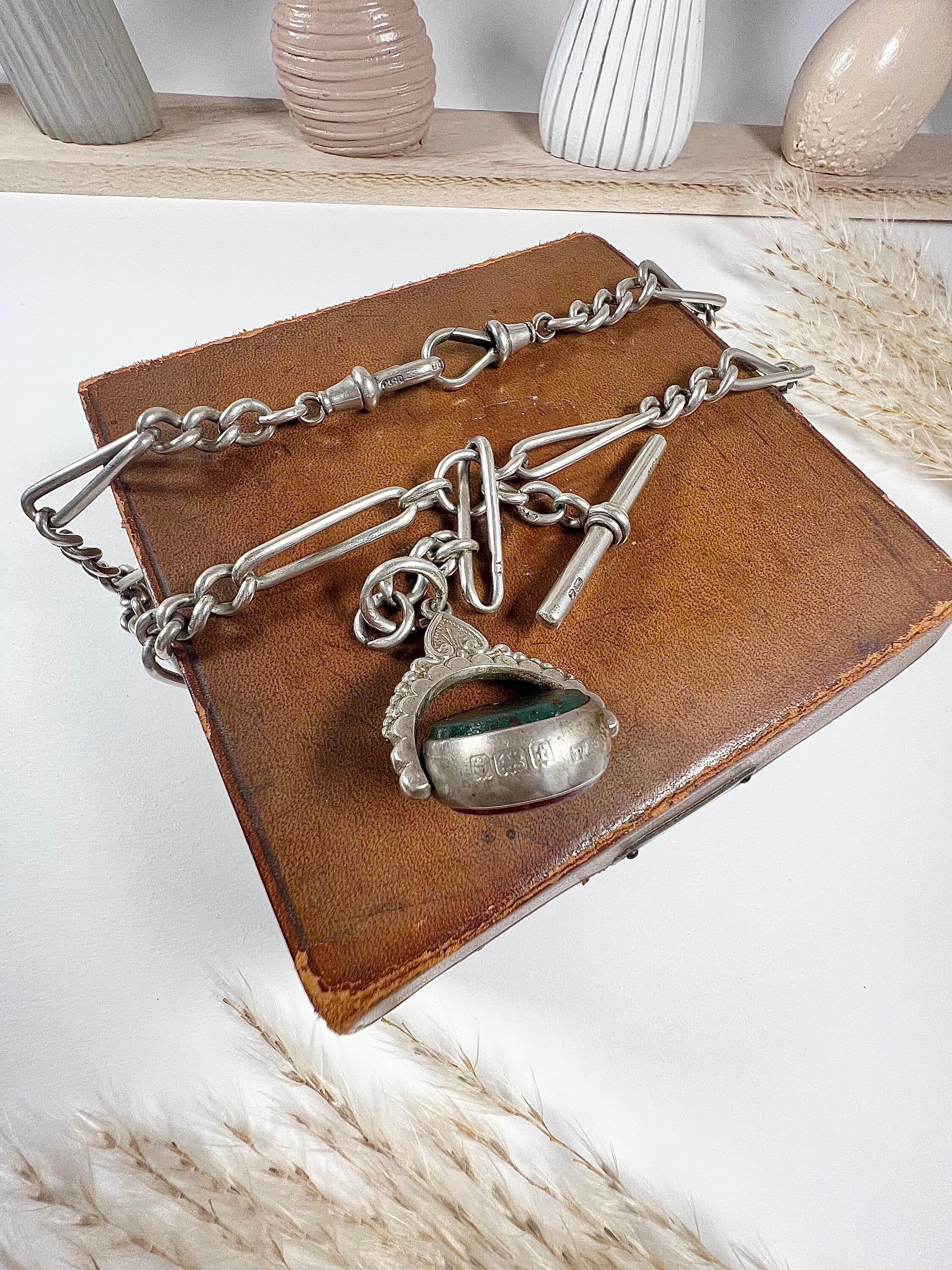 Antique Albert Chain

Sterling Silver Stamped

Chain Hallmarked Birmingham 1899

Fob Hallmarked Birmingham 1905

Makers Mark J S 

Fabulous, Victorian, double silver watch chain.  
Beautiful figaro link stamped for silver on each & every link.