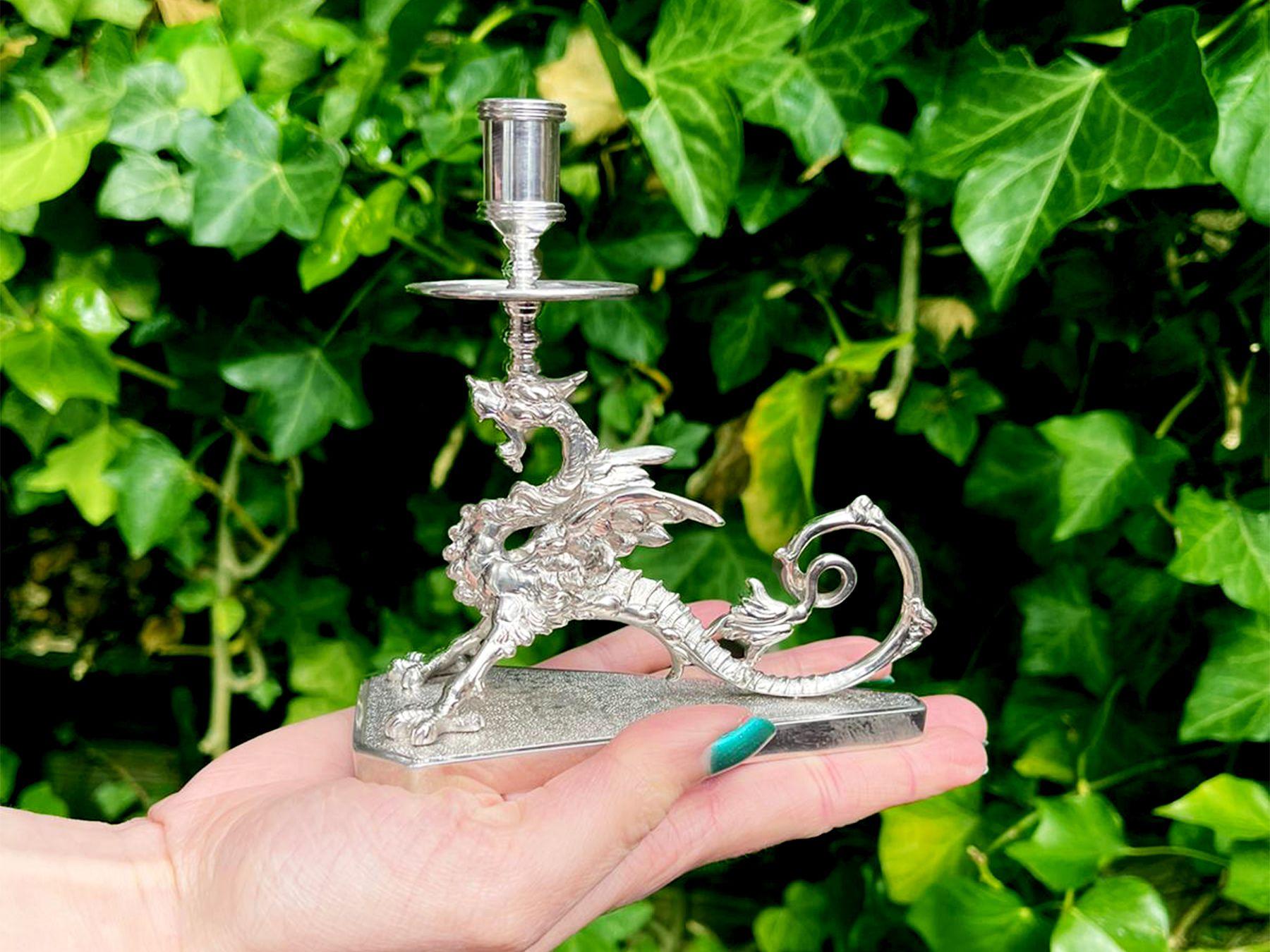 An exceptional, fine and impressive antique Victorian English sterling silver wyvern taperstick; an addition of our ornamental silverware collection.

This exceptional antique Victorian sterling silver taperstick/taper candlestick has a tapering