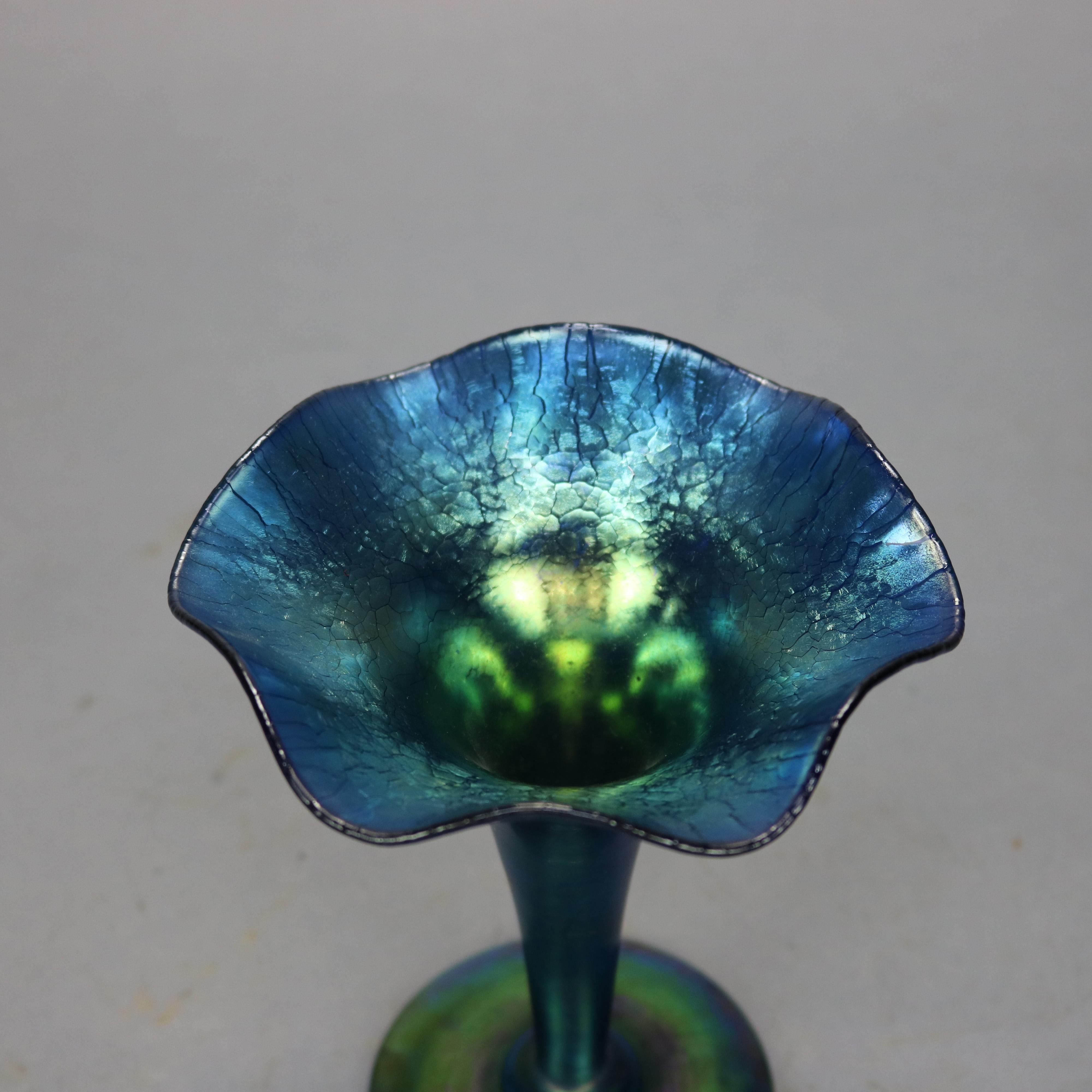 An antique fluted vase by Steuben offers blue Aurene art glass in trumpet form with ruffled rim, signed 