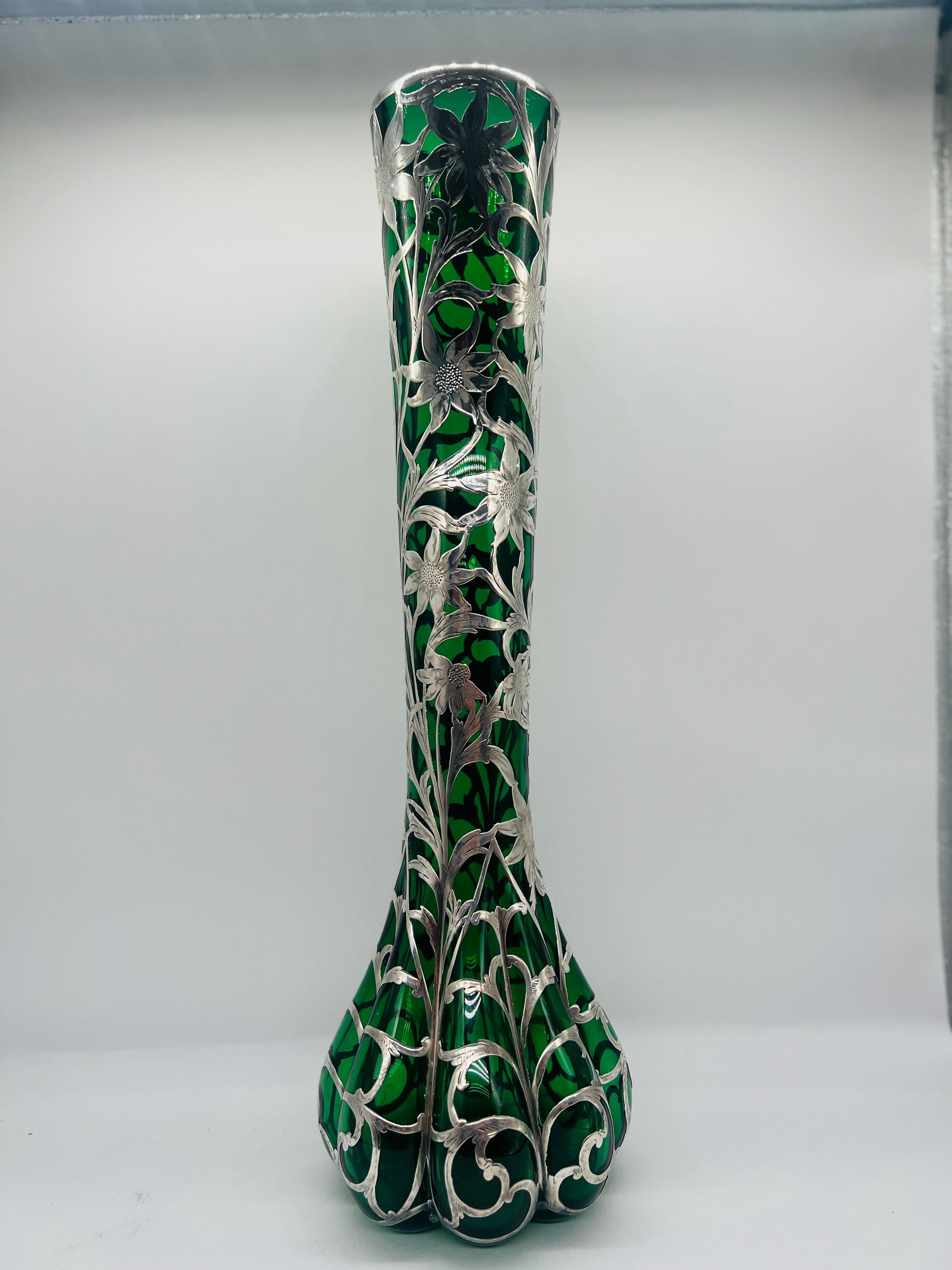 Steuben (American, founded 1903), circa early 20th century. 

This exquisite antique Steuben emerald glass vase is beautifully adorned with an Alvin sterling silver sunflower overlay, showcasing the perfect marriage of American glassmaking artistry