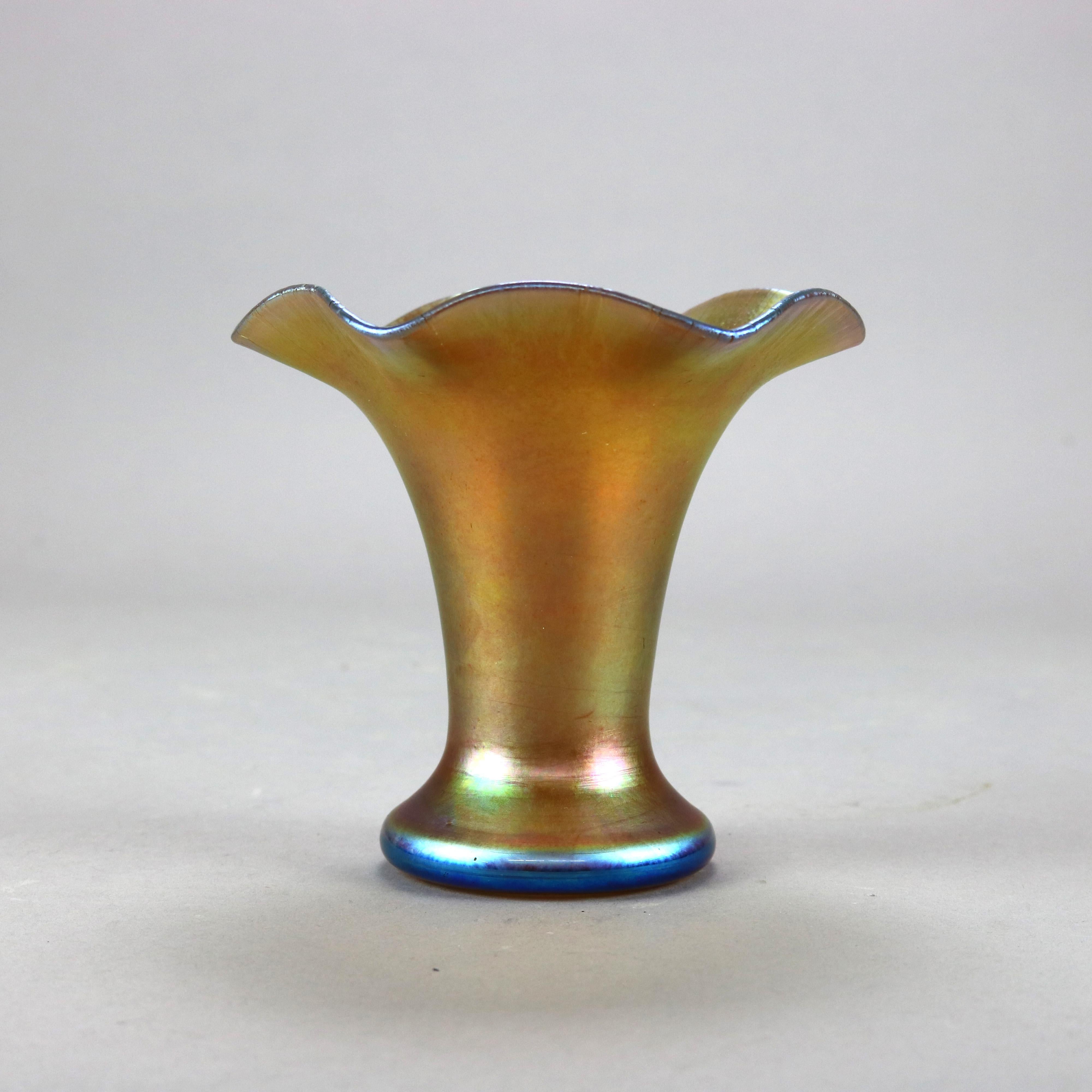 An antique vase by Steuben offers gold aurene art glass construction in flared and squat form with ruffled rim, etched Aurene with Rockwell Museum label, c1920

Measures - 5.5