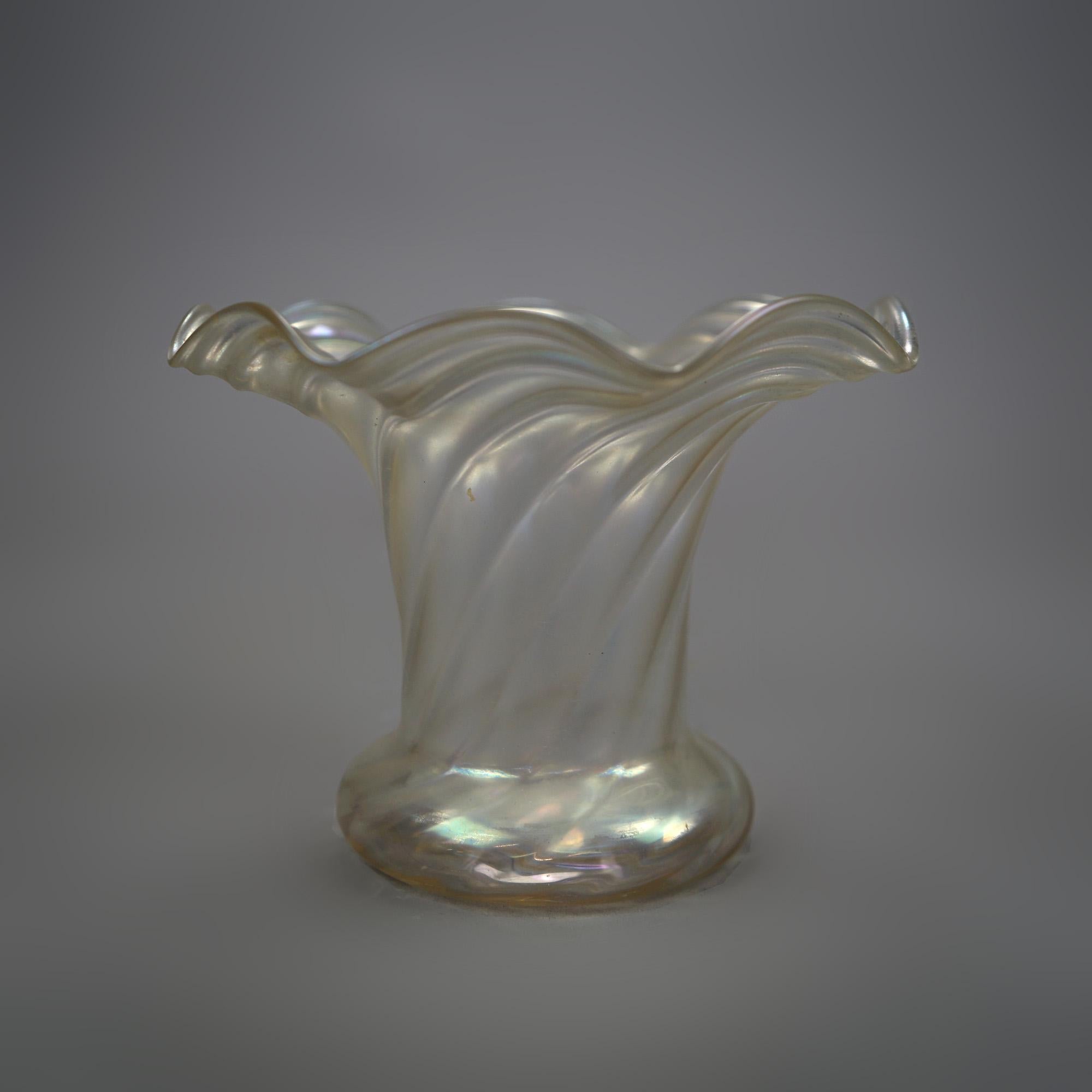 An antique Verre De Soie vase by Steuben offers swirled art glass construction in squat form with ruffled rim, unsigned, c1920.

Measures- 5''H x 6.25''W x 6.25''D.

Catalogue Note: Ask about DISCOUNTED DELIVERY RATES available to most regions