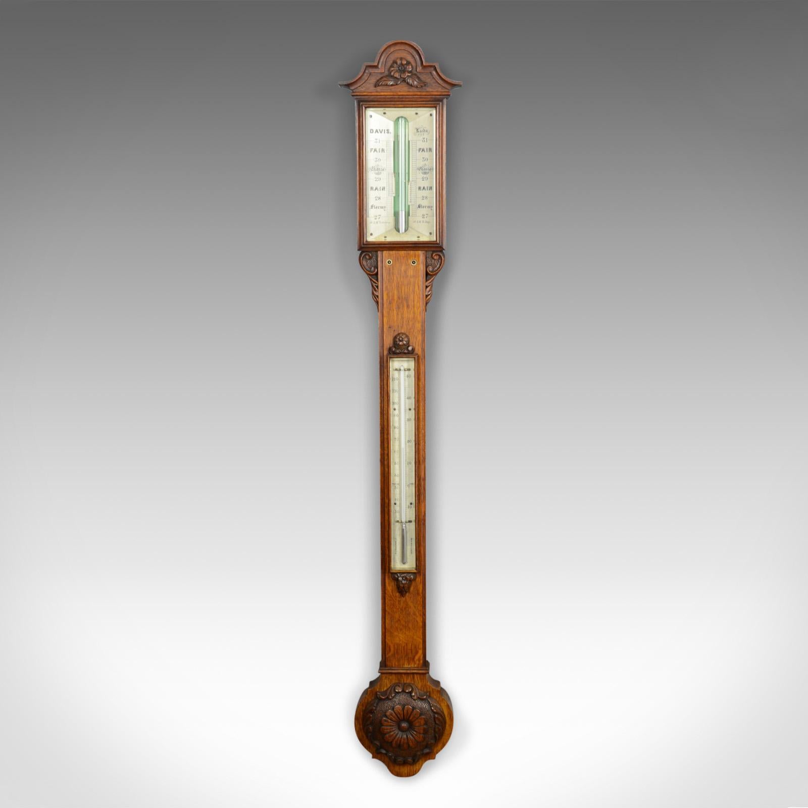 This is an antique stick barometer by Davis of Leeds. English, oak and dating to the early 19th century, circa 1830.

Of fine quality by renowned maker, Davis of Leeds
Cased in English oak displaying grain interest and a desirable patina
Bright,