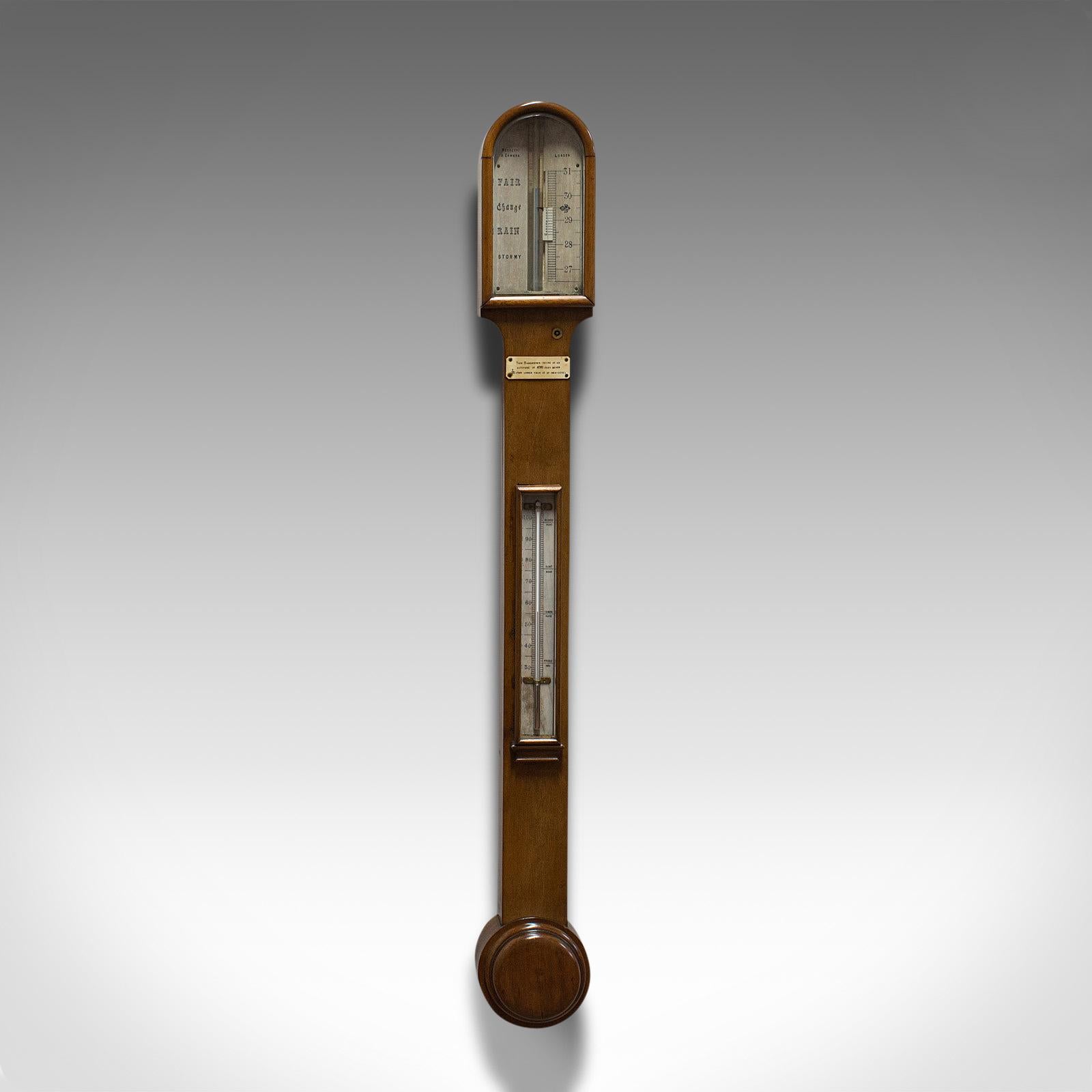 This is an antique stick barometer. An English, walnut scientific instrument with thermometer by Negretti & Zambra, dating to the late Victorian period, circa 1900.

Presented in the classic stick barometer style
Displays a desirable aged