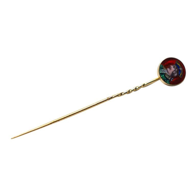 Antique stick pin in 18k gold. Its a painted profile of a young gentleman. The painting in enamel is adorned with a diamond in the man’s tricker hat.