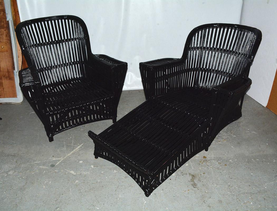 Antique American Art Deco split reed stick wicker chaise lounge and matching armchair woven of willow, newly painted in black paint. Rounded back design with flat armrest. Reed is rattan when it is sprouting. It is a durable fibrous material similar