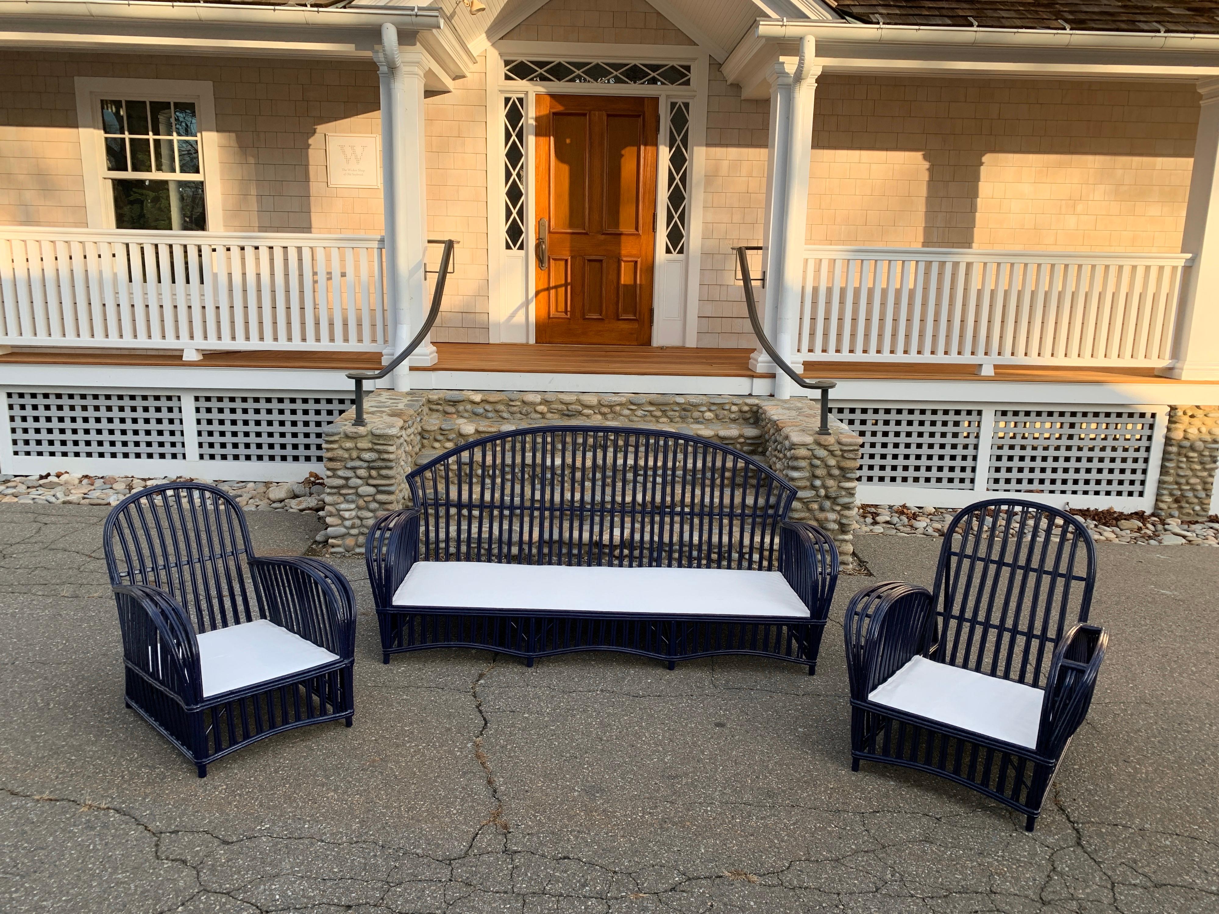 Vintage stick rattan set newly painted in Benjamin Moore Admiral blue. Additional chairs are available and can be painted to match. Sofa measures 82