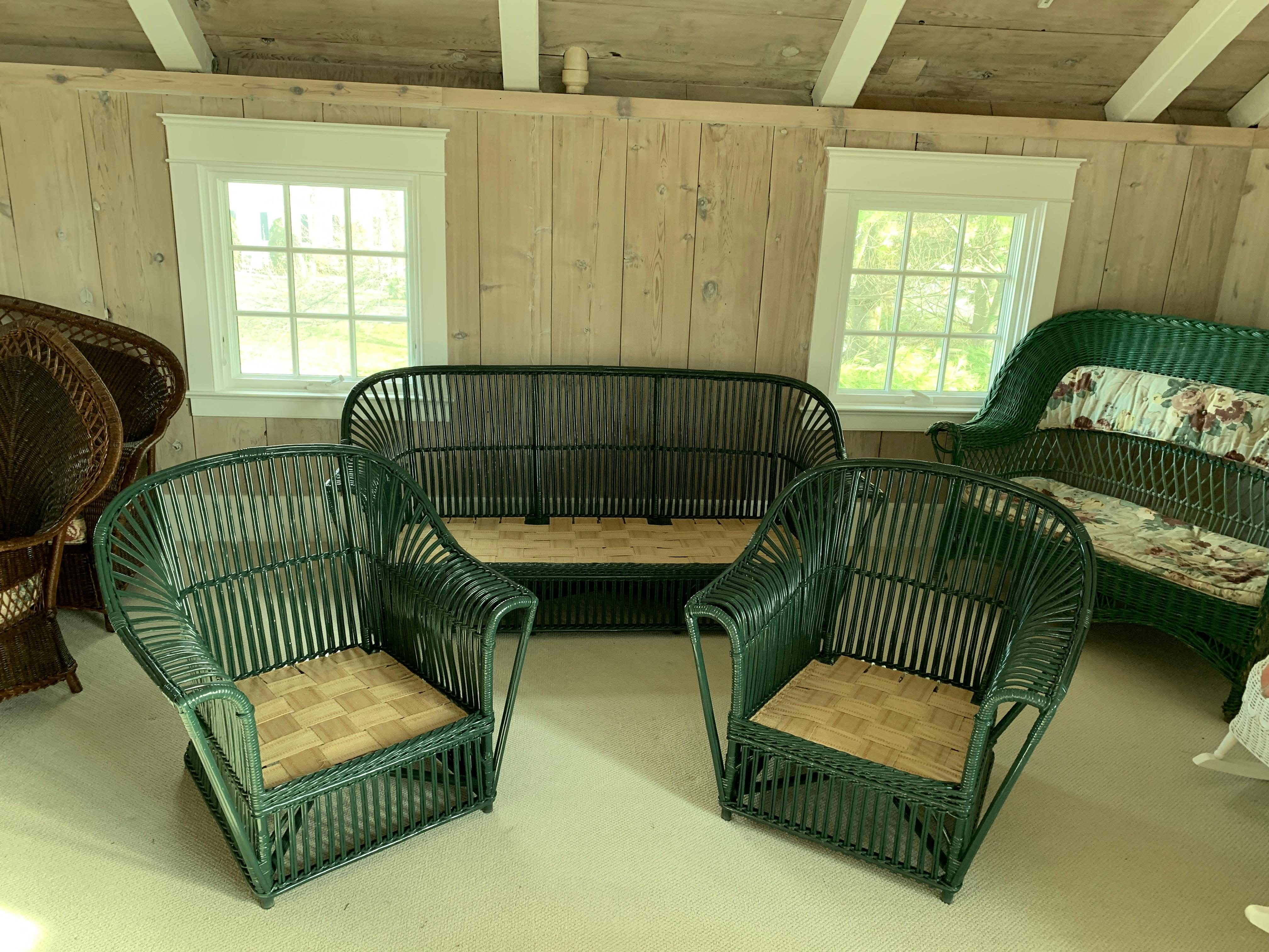 Three piece stick rattan seating in hunter green paint. Two matching lounge chairs and sofa freshly painted with fresh decking over springs. Sofa measures 74
