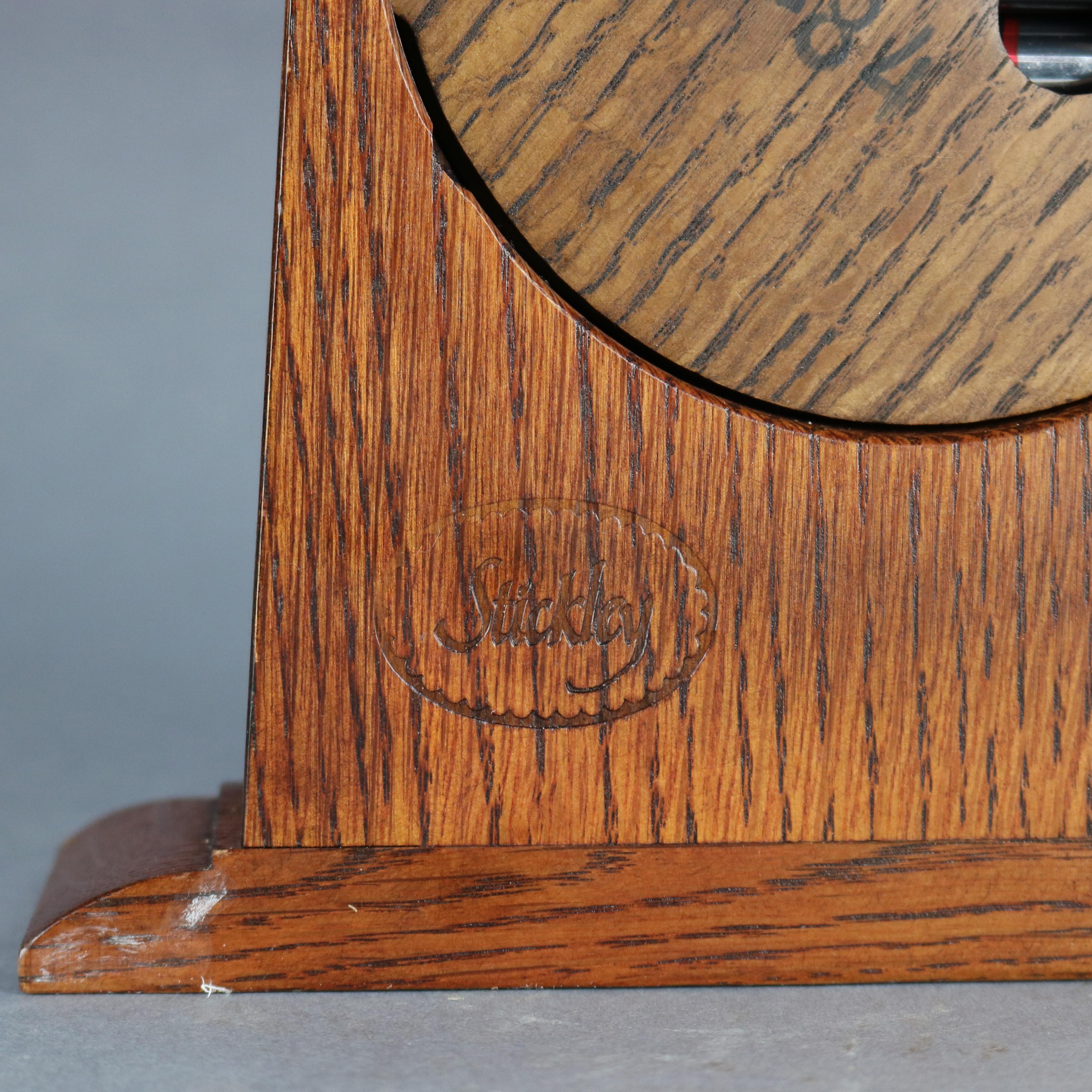 An antique Arts & Crafts mission mantle clock by Stickley offers oak construction, battery operated, signed and labeled en verso as photographed, 20th century

Measures: 8.5