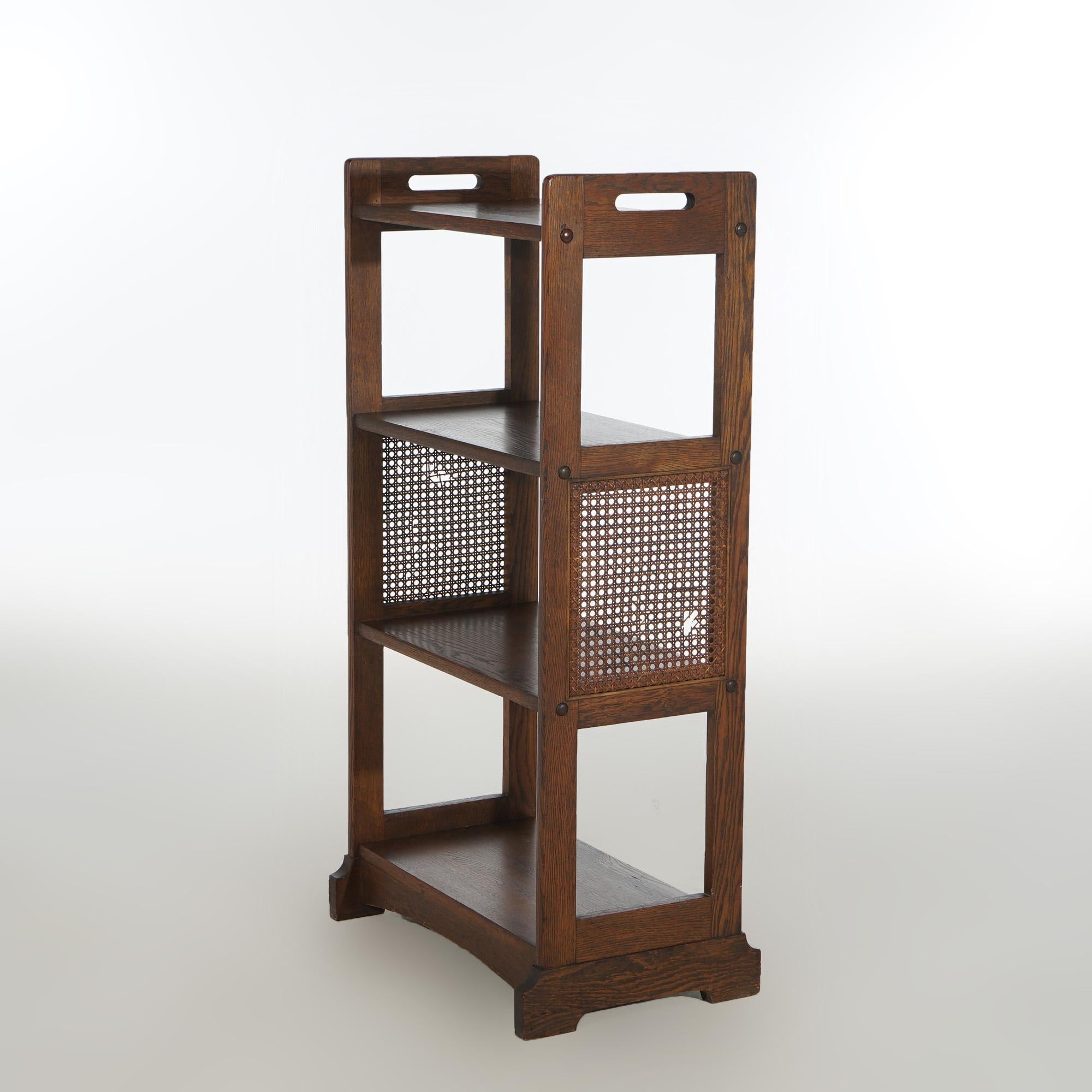 Antique Stickley Brothers Mission Oak Arts & Crafts Book Stand with Cutout Handles and Pressed Cane Sides, C1910

Measures - 42.5