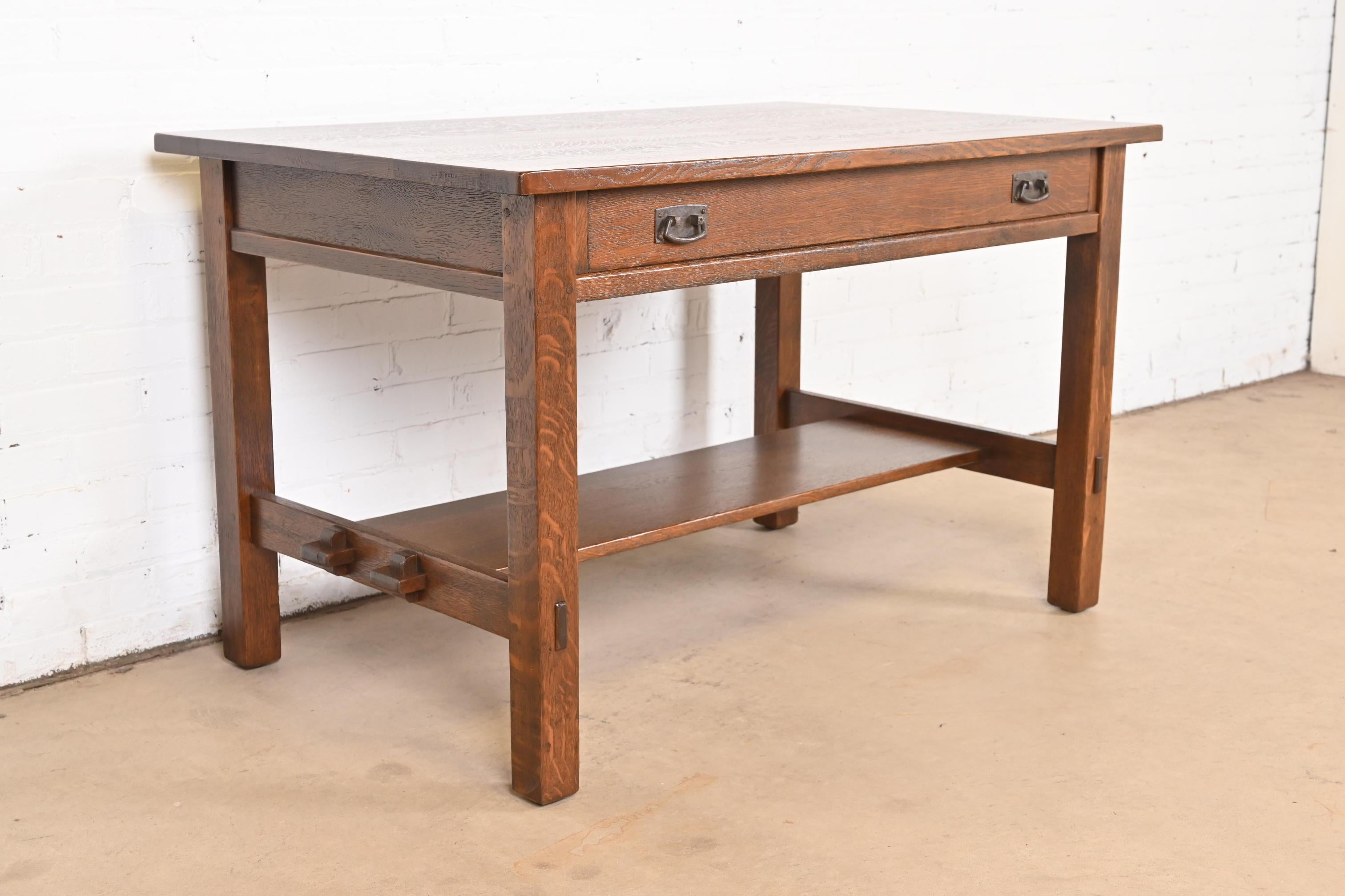 An exceptional antique Mission or Arts & Crafts writing desk or library table

By L. & J.G. Stickley

USA, Circa 1900

Solid quarter sawn oak, with original hammered copper hardware.

Measures: 48