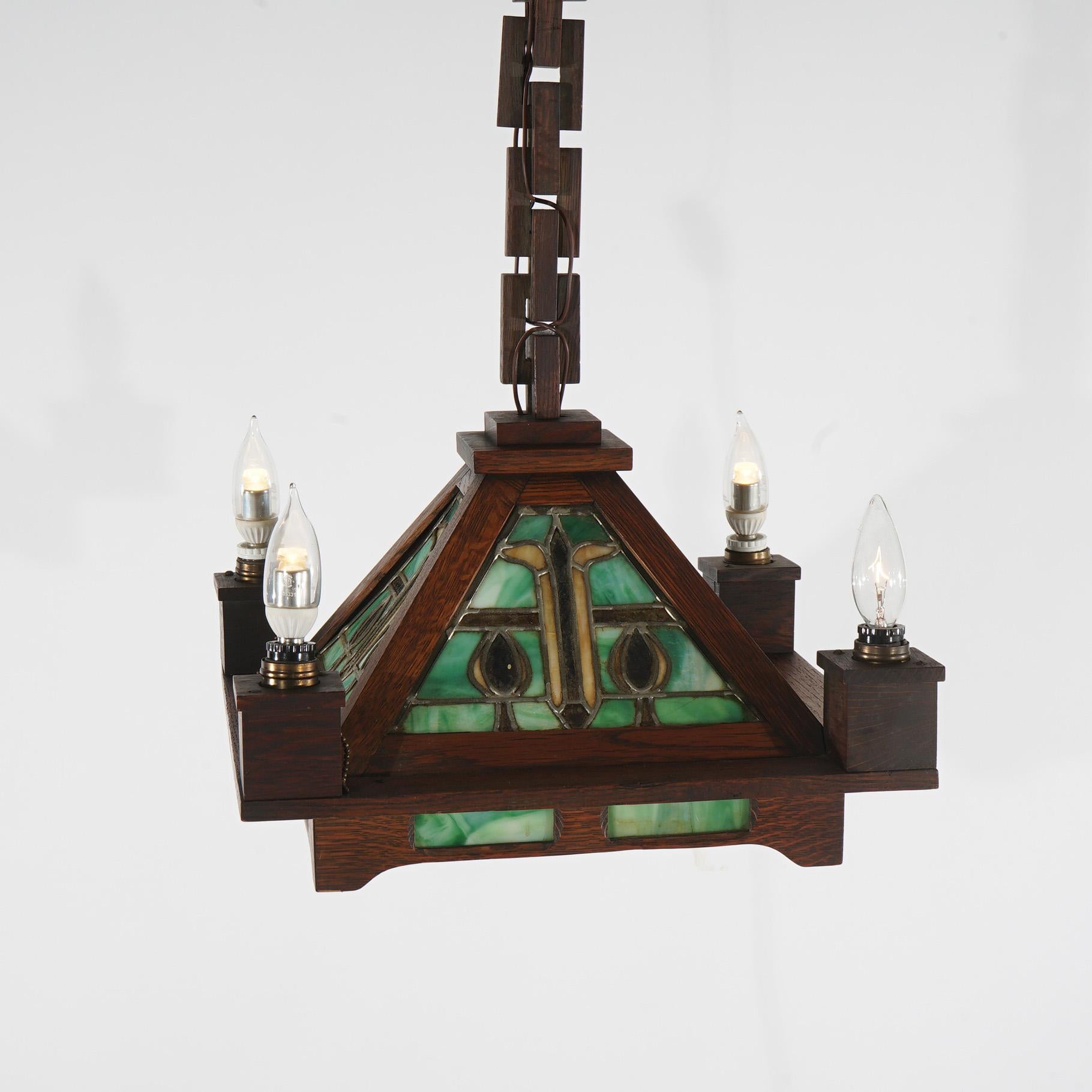 Antique Stickley School Arts & Crafts Mission Oak Leaded Slag Glass Chandelier with Candle Lights & Carved Wood Chain c1910

Measures- 33.5''H x 15.5''W x 15.5''D