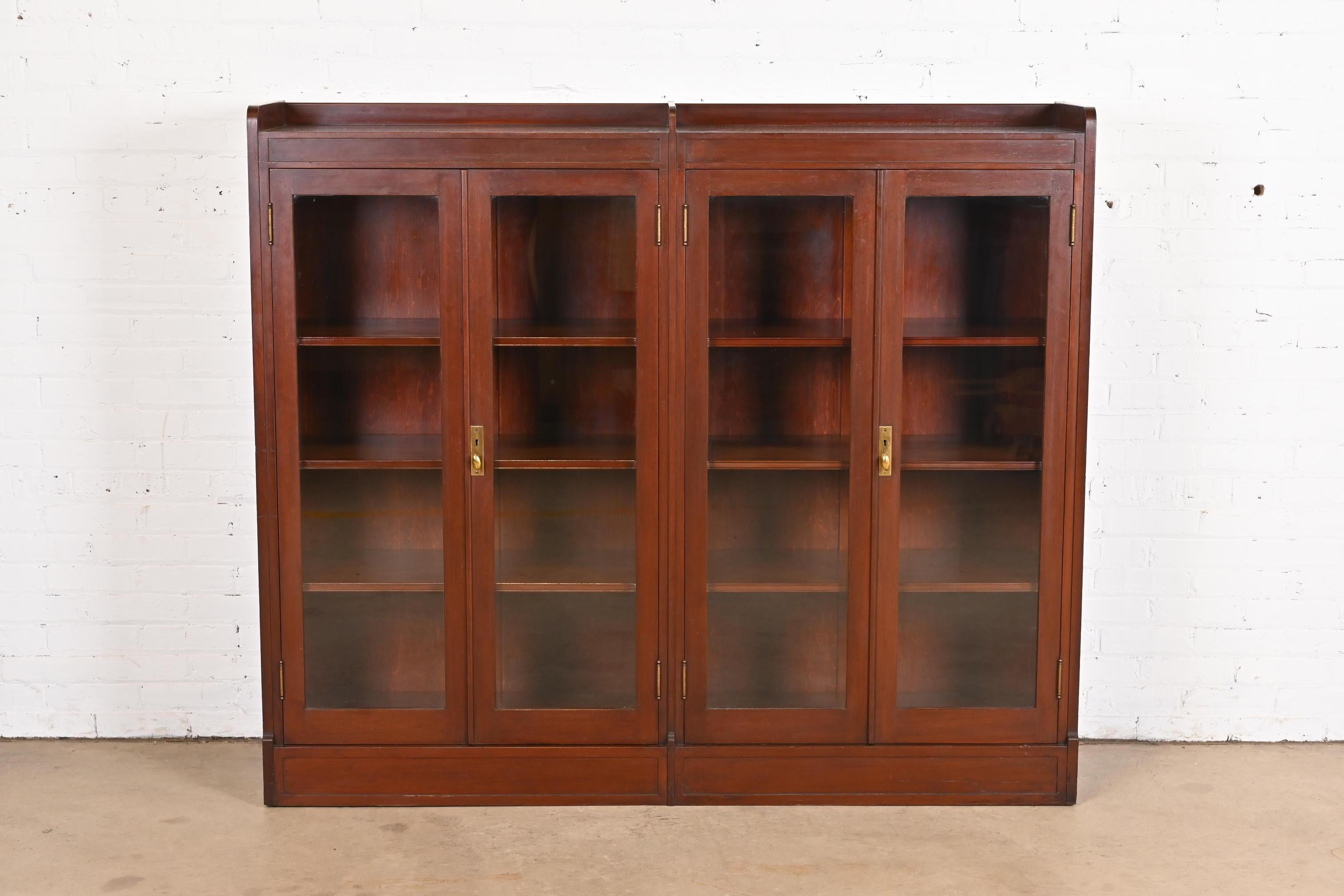 A gorgeous antique Arts & Crafts four-door double bookcase

In the manner of Stickley

USA, Circa 1920s

Solid mahogany, with glass front doors, and original brass hardware.

Measures: 66