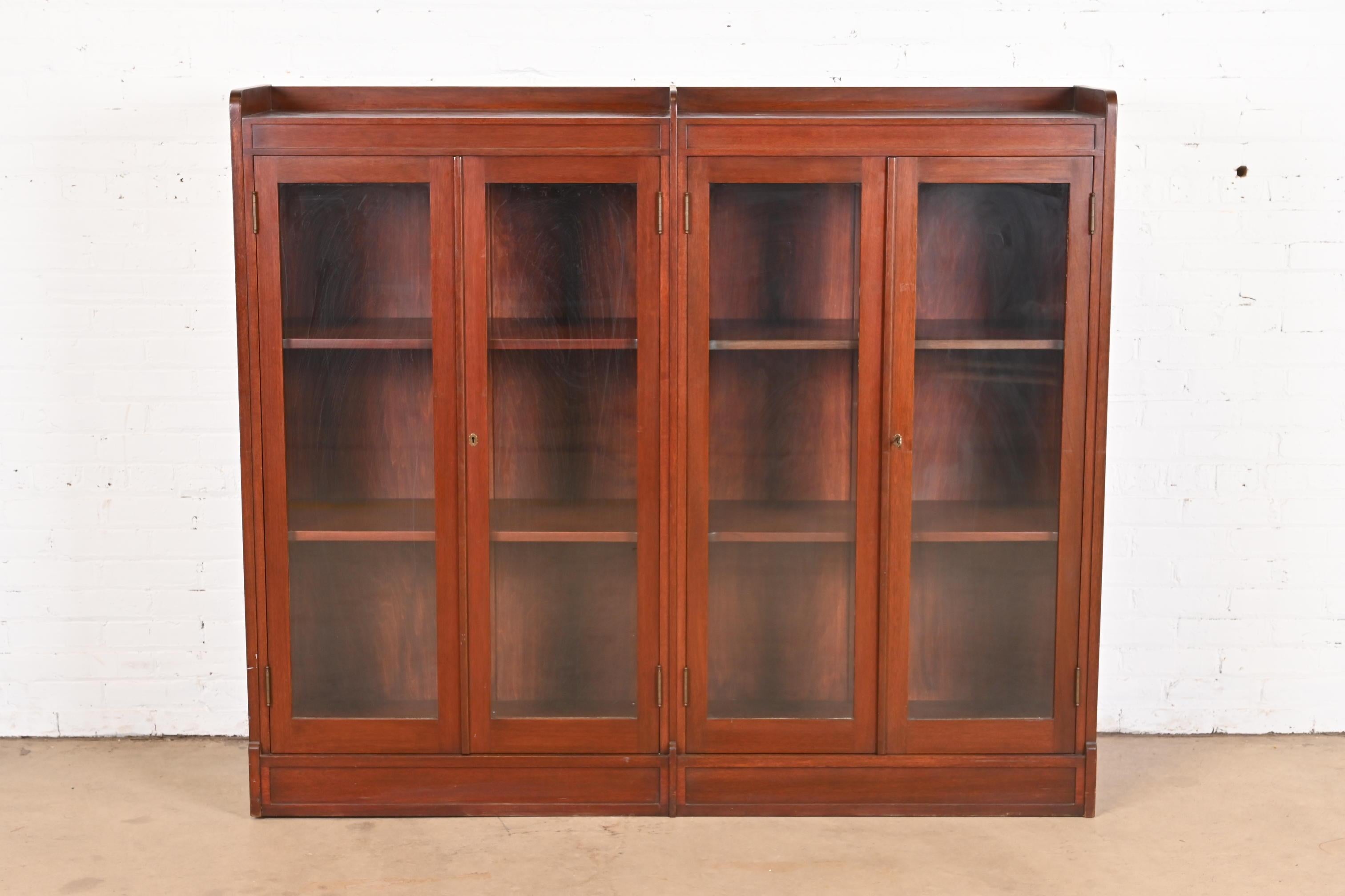 A gorgeous antique Arts & Crafts four-door double bookcase

In the manner of Stickley

USA, Circa 1920s

Solid mahogany, with glass front doors, and original brass hardware. Cabinet locks, and key is included.

Measures: 66