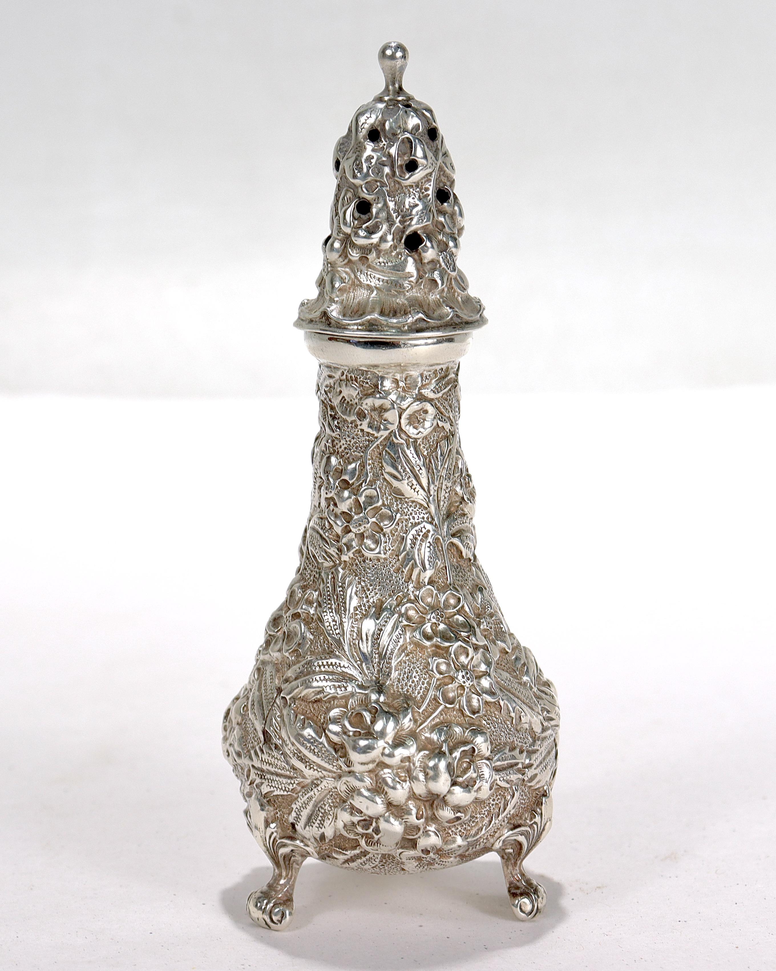 A fine antique silver salt shaker.

In sterling silver.

By Stieff.

With repousse flower decoration throughout and 3 small feet. 

Simply a great salt shaker!

Date:
Early 20th Century

Overall Condition:
It is in overall good, as-pictured, used