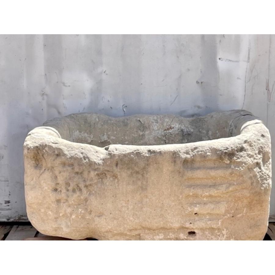 Small - Medium stone basin. Rectangular in shape with irregular sides due to wear and erosion over time. Great for a small planter for herbs or flowers in a garden.