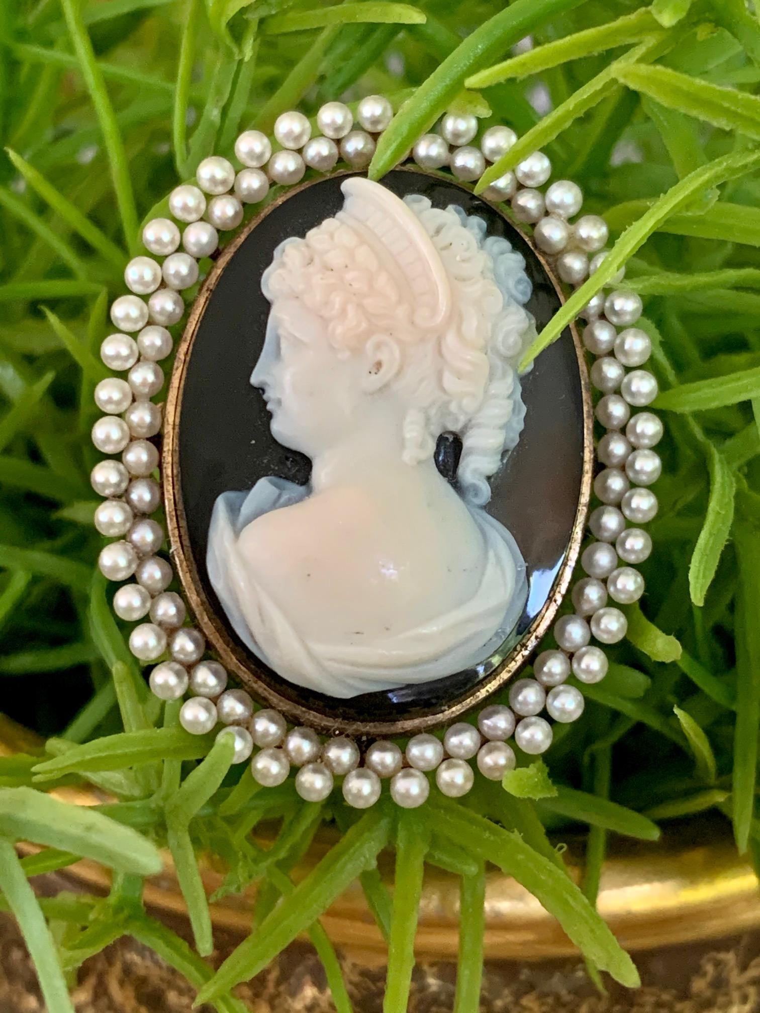 This antique Cameo is beautifully carved in stone, down to the last detail of every curl in this lovely lady's locks.  She is encircled by a double halo of Pearls.  This piece can be worn as a pendant or a brooch.

This is stamped: 14k. 

Size 38 x