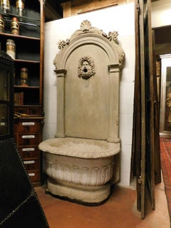 Antique stone fountain with basin and mask, carved tritons and shell, '700 Italy