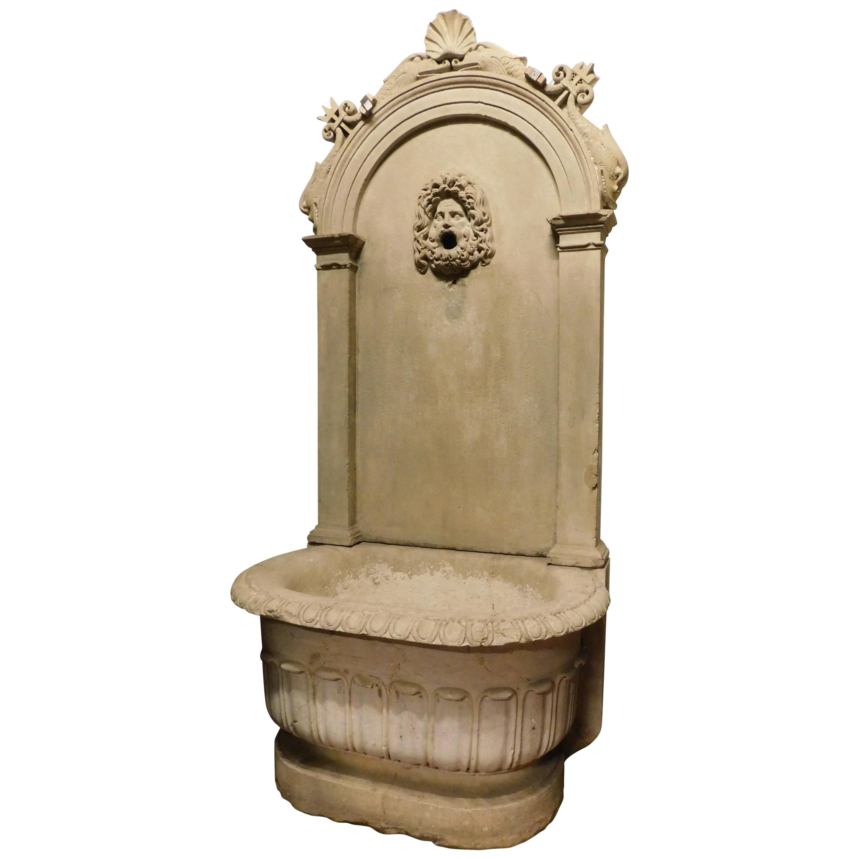 Antique stone fountain with basin and mask, carved tritons and shell, '700 Italy