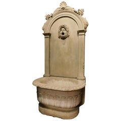 Antique stone fountain with basin and mask, carved tritons and shell, '700 Italy