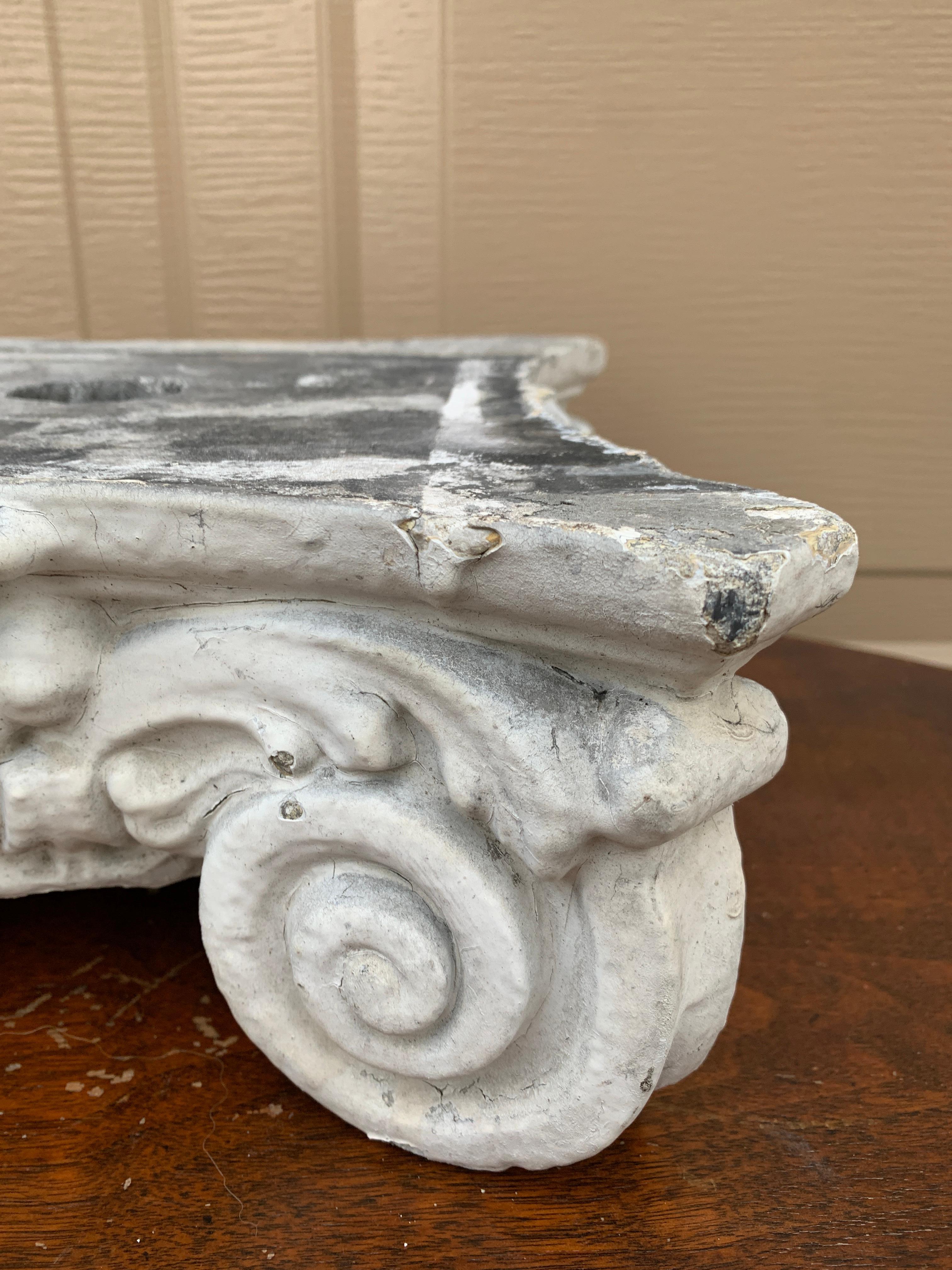 A stunning Greek or Roman Neoclassical style cast stone Ionic column capital. This piece of architectural salvage would make a lovely objet d'art, sculpture, garden ornament, or stand for a sculpture or plant.

USA, Late 19th Century

Measures: