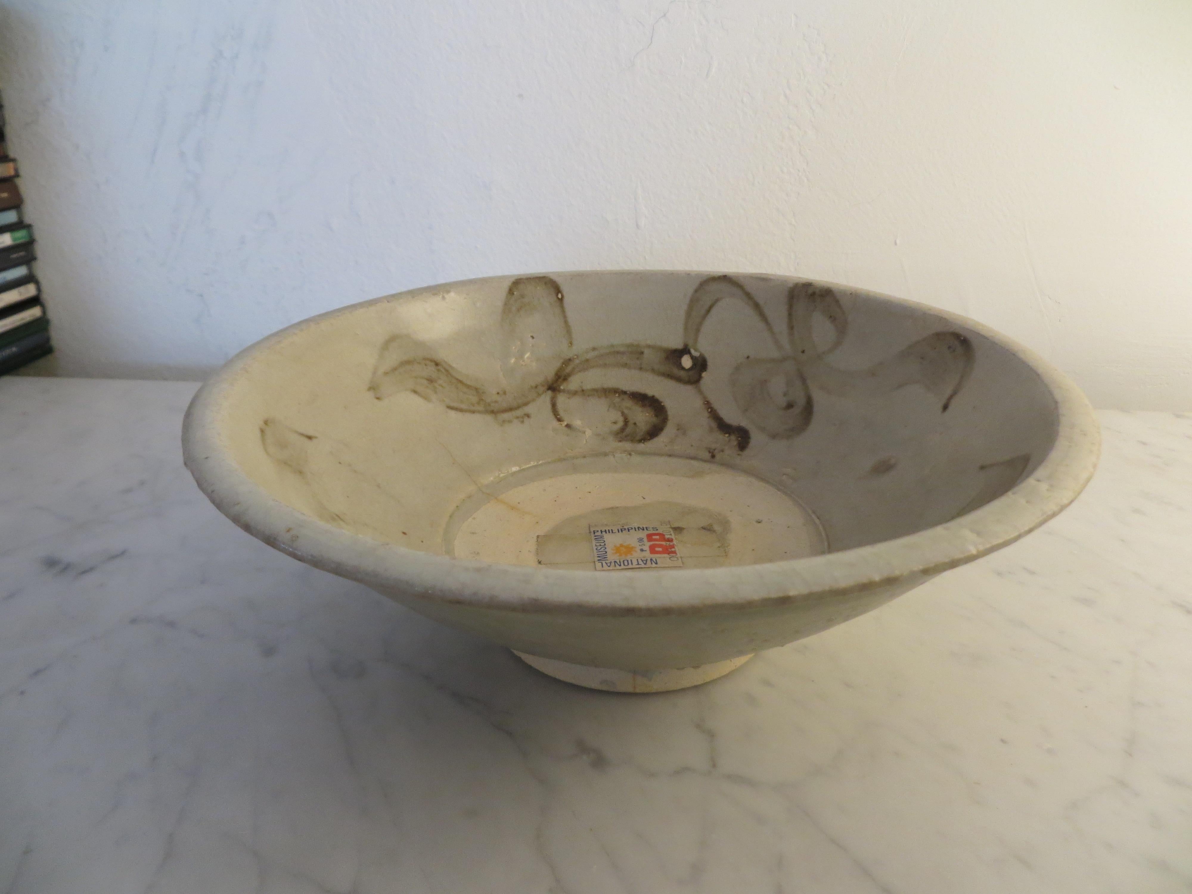 Antique stoneware Chines bowl. We are not sure of the period, could be Sung or Yuan Ming.
It was purchased in the Philippines about 15 years and it has an authenticity sticker label from the Philippines National Museum.
The bowl has a viable 2
