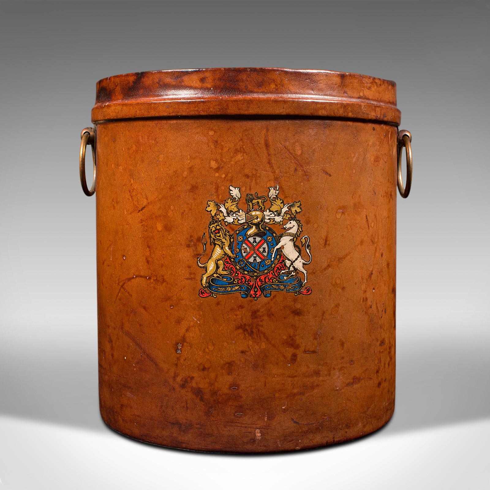 This is an antique storage bin. An English, leather and brass bucket or store, dating to the late Victorian period, circa 1900.

Presents a colourful, and pleasingly weathered antique appeal
Displays a desirable aged patina throughout
Leather bound