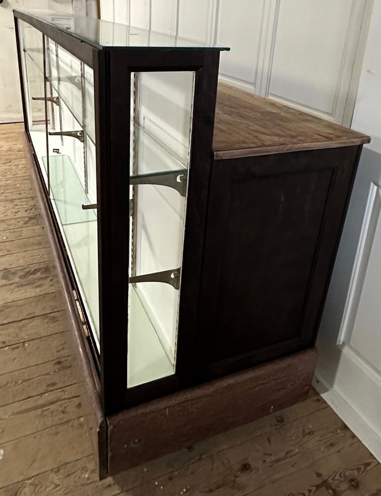 A late 19th / early 20th century industrial general store display case work or shop counter, having a 17