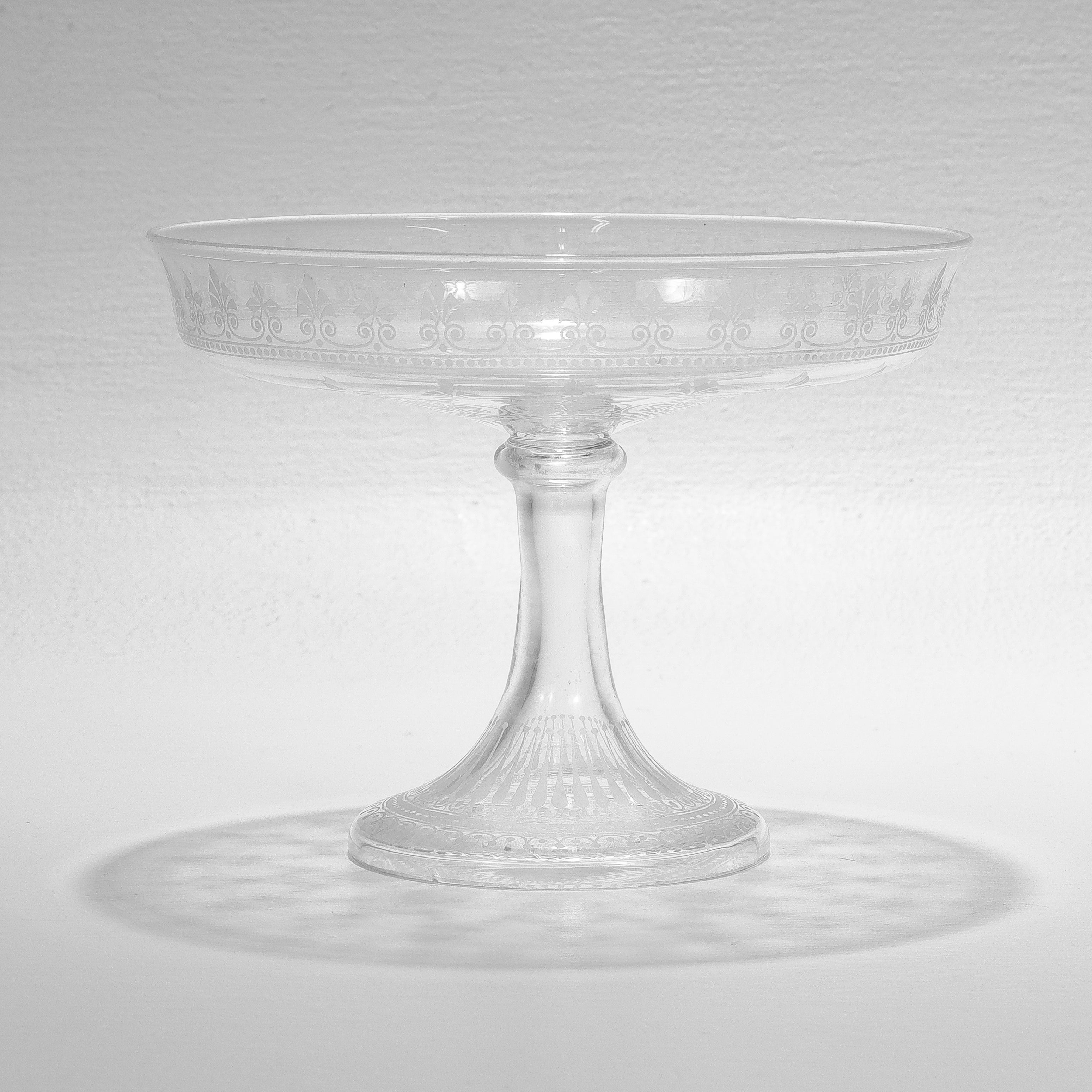 A fine antique etched and engraved glass tazza or compote.

Attributed to Stevens & Williams or Webb.

With engraved & etched geometric designs and leafy devices.

Simply a wonderful English glass compote!

Date:
Late 19th or Early 20th