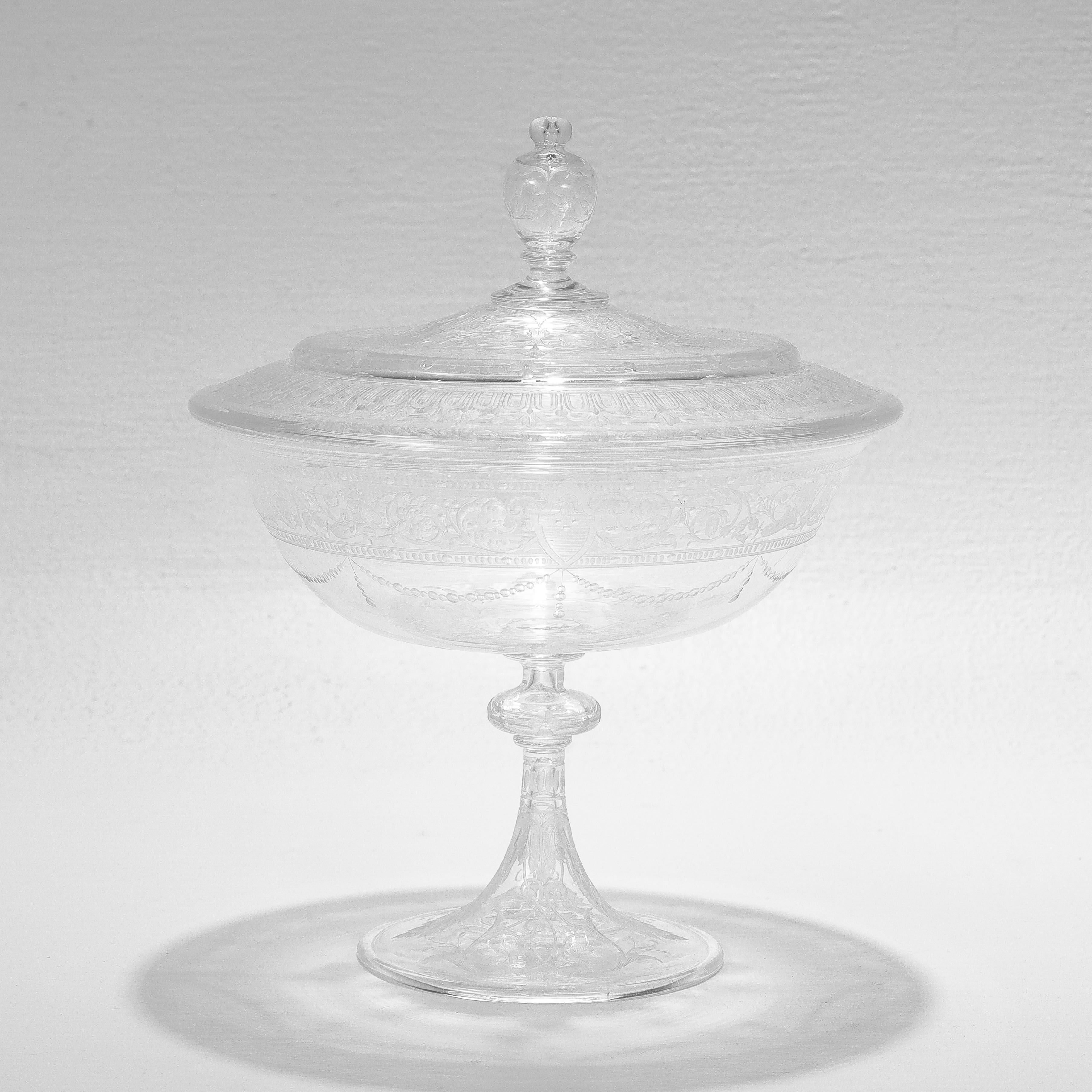 A fine antique etched and engraved glass tazza or compote.

Attributed to Stevens & Williams or Webb.

With engraved & etched flowers, leaves, and geometric designs,

The lid is topped with a decorative finial handle.

Simply a wonderful