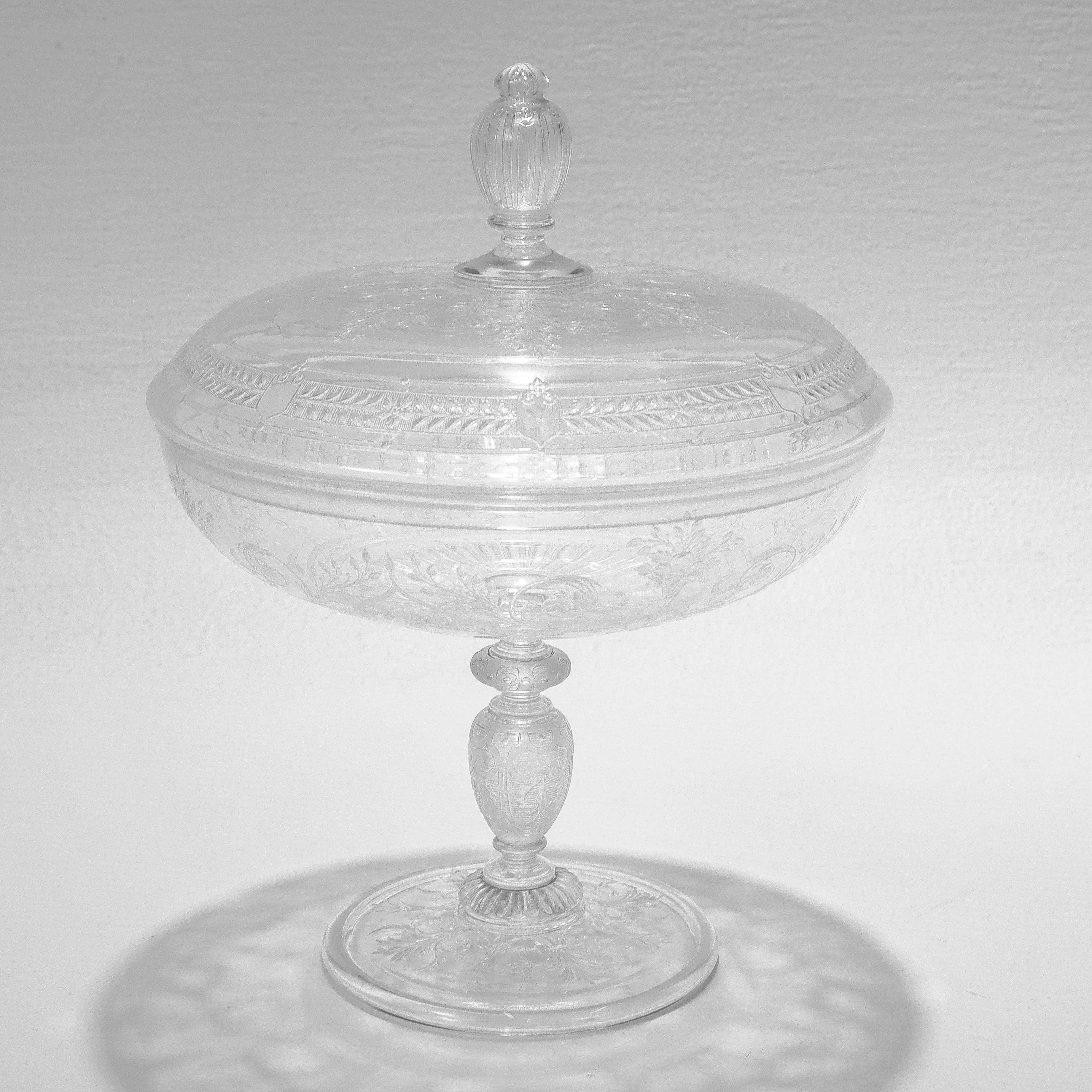 A fine antique etched and engraved glass tazza or compote.

Attributed to Stevens & Williams or Webb.

With engraved & etched leaves, fruits, and geometric designs.

The lid is topped with a decorative finial handle.

Simply a wonderful