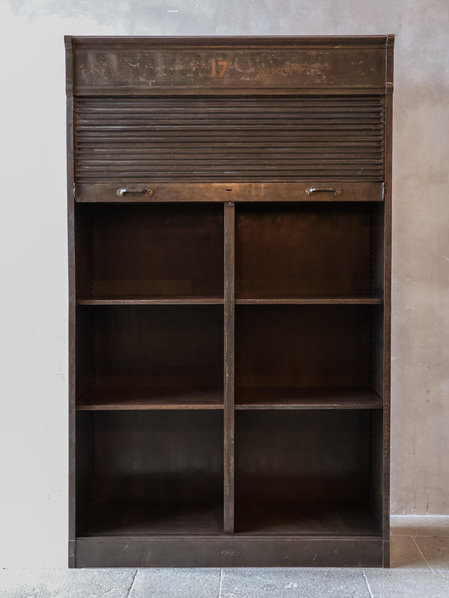 The early 20th-century iron roll-front archive cabinet by Strafor is a uniquely functional piece with a rich history. Created by the renowned French brand Strafor, known for its production of durable metal office furniture, this cabinet is a true