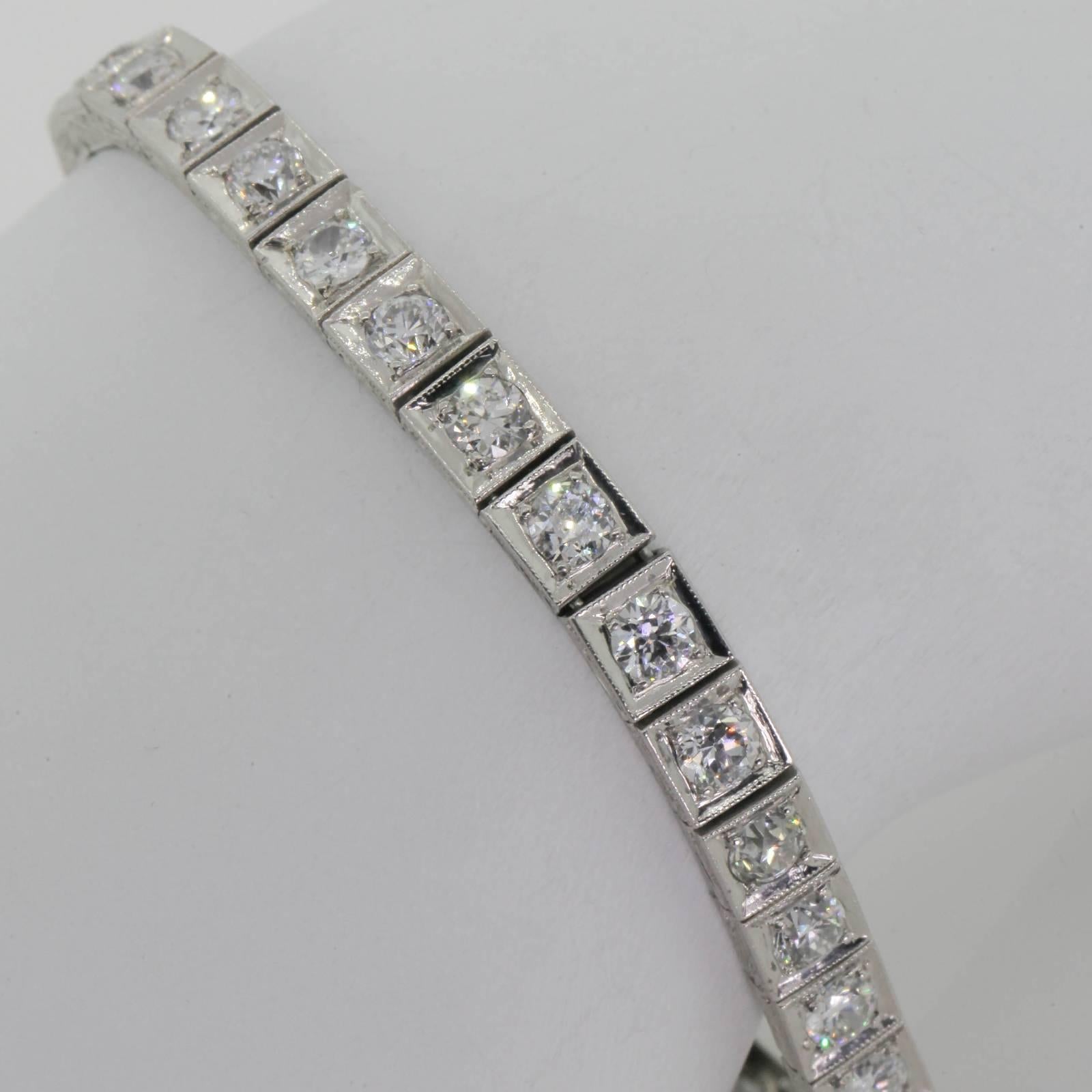 The iconic 1920s box design straight line bracelet, fabricated in platinum and set with thirty three Old European Cut Diamonds.  All diamonds weigh 6.60 carats of H/I color - VS/SI clarity.  The sides of the bracelet are enhanced with hand