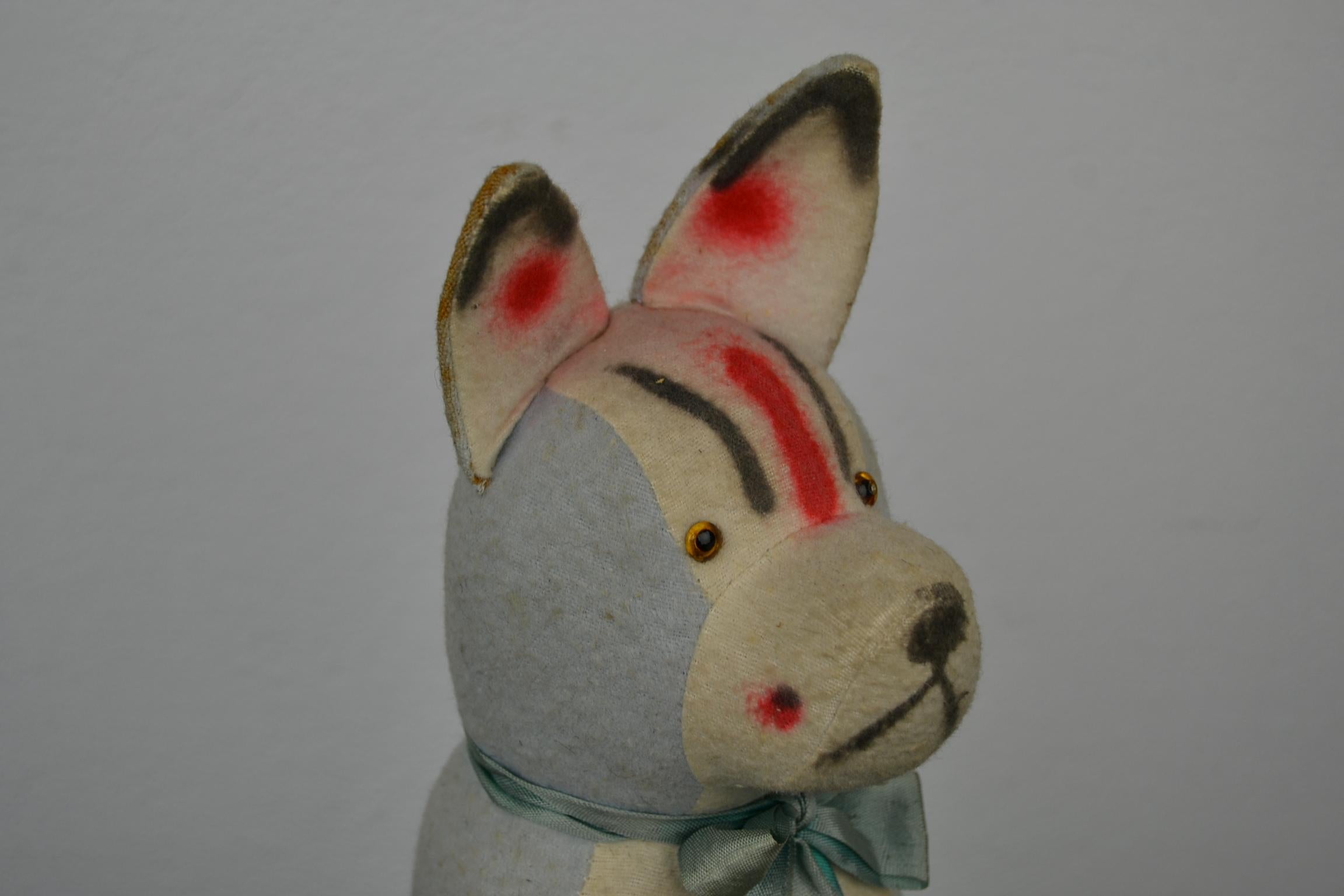 Antique German Stuffed toy in the shape of a French bulldog dog. This antique toy is stuffed with straw, has glass eyes, metal wire in the ears to keep the ears up. This toy dates circa 1920s-1930s. This handmade toy was made in Germany. The fabric