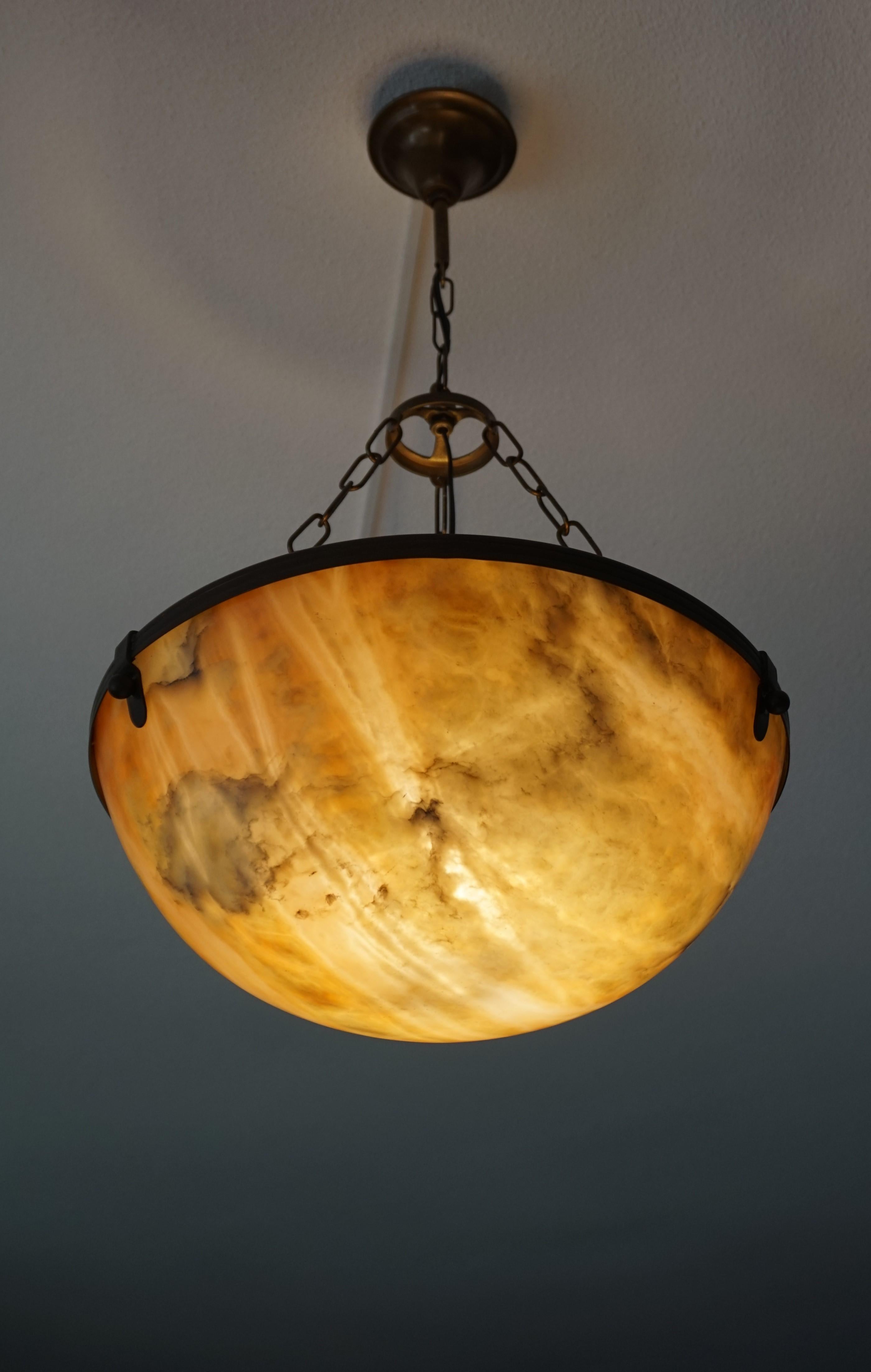 Stylish and excellent condition alabaster in brass frame light fixture.

If you are looking for a beautiful and stylish light to grace your living space then this early 1900s, mineral stone pendant could be the one. All handcrafted in the Arts &
