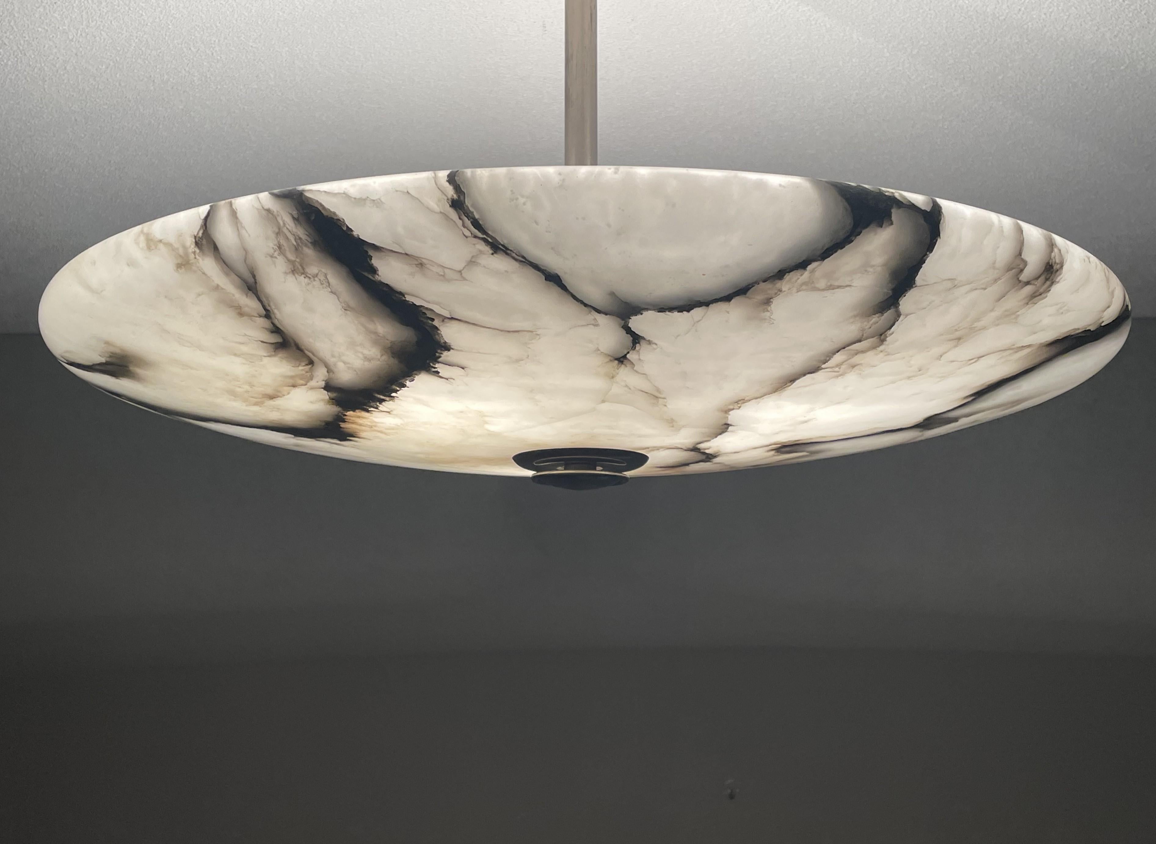 One of a kind and truly attractive, three light alabaster flushmount.

This unique and extra large antique light fixture comes with a stunningly polished alabaster shade. With the black veins being as evenly divided as they are (among the best we