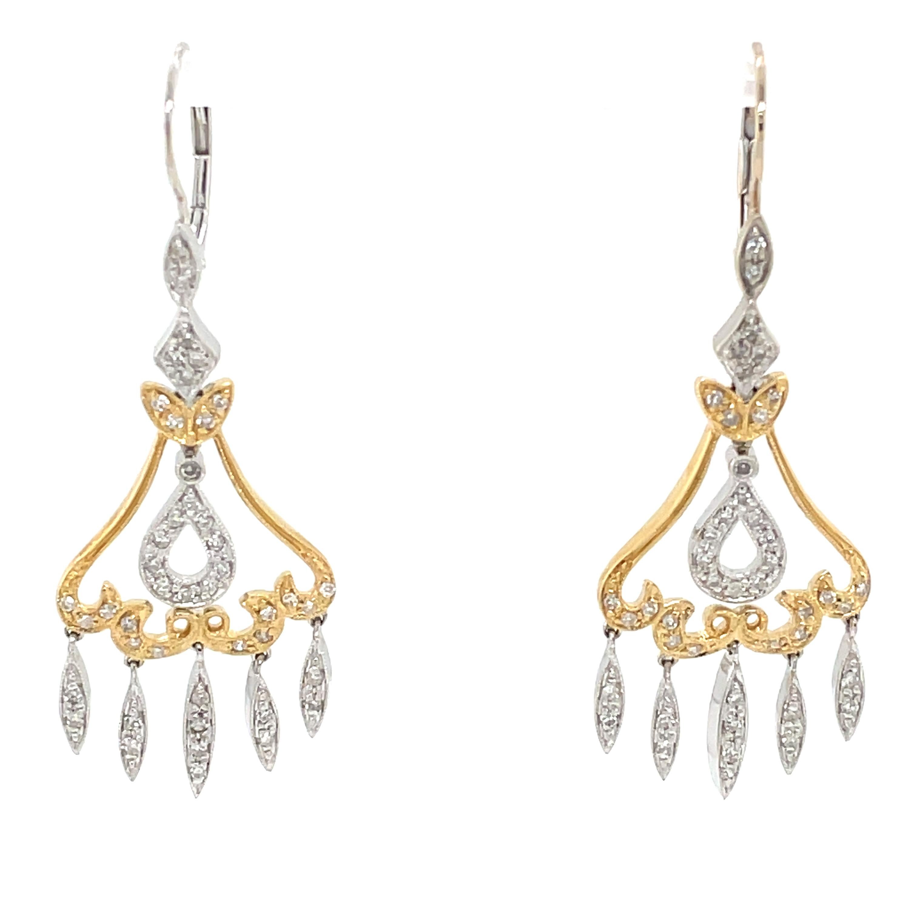 Bright white diamonds light up this two tone elegant pair of 14 karat white and yellow gold chandelier earrings. Dramatic, the pair is very versatile and perfect for bridal, a formal occasion or to dress up an evening wardrobe favorite. The diamond