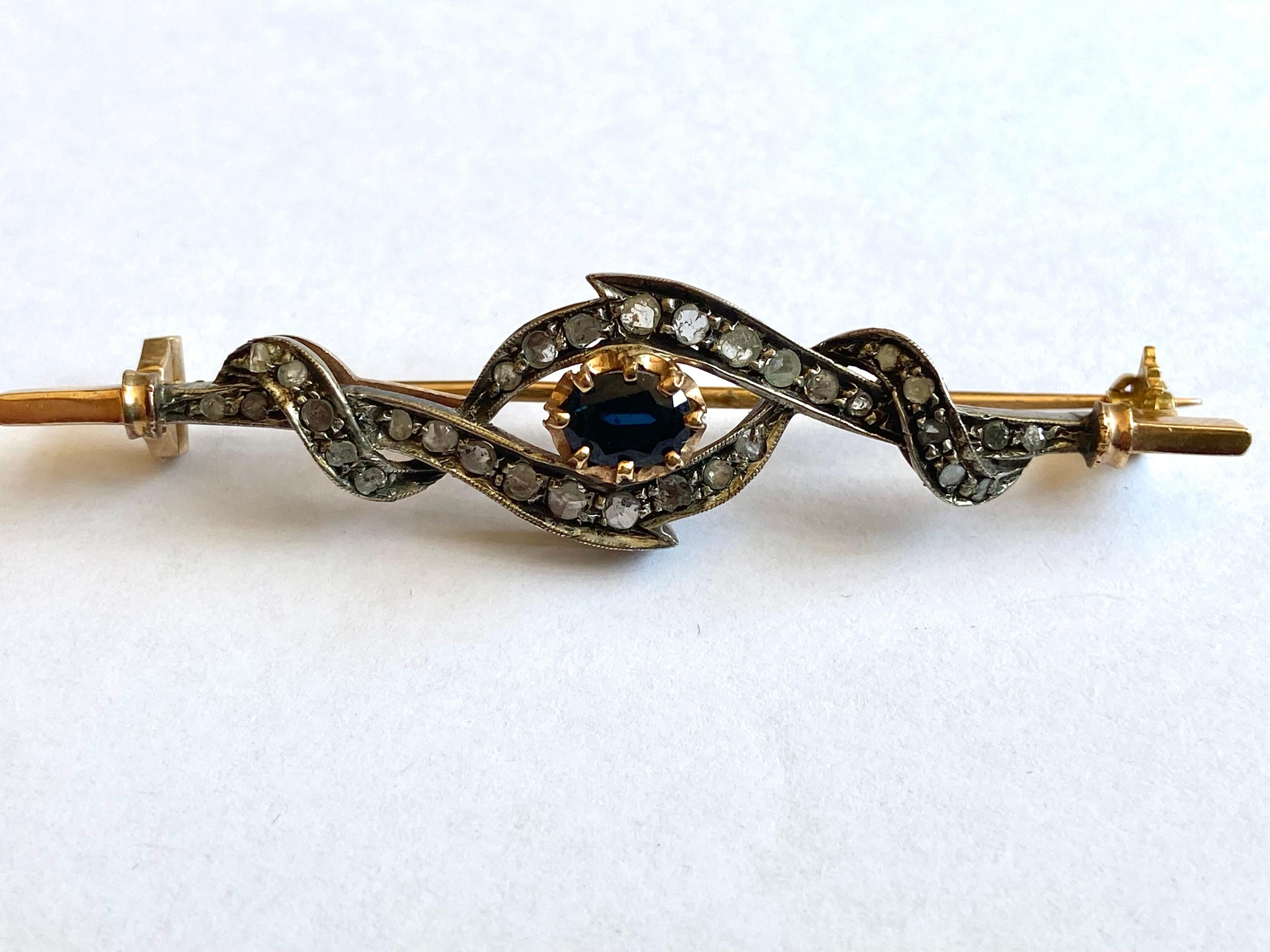 Antique style brooch, 14 kt gold, 800 silver, diamonds, sapphire.Almost 7 cm long.
Made by skilled artisans of Torredel Greco (Naples). 14 Kt gold and 800 silver. Set rose cut diamonds, 0.70 ct and natural sapphire, 0.35 ct. Pin with safety. Weight