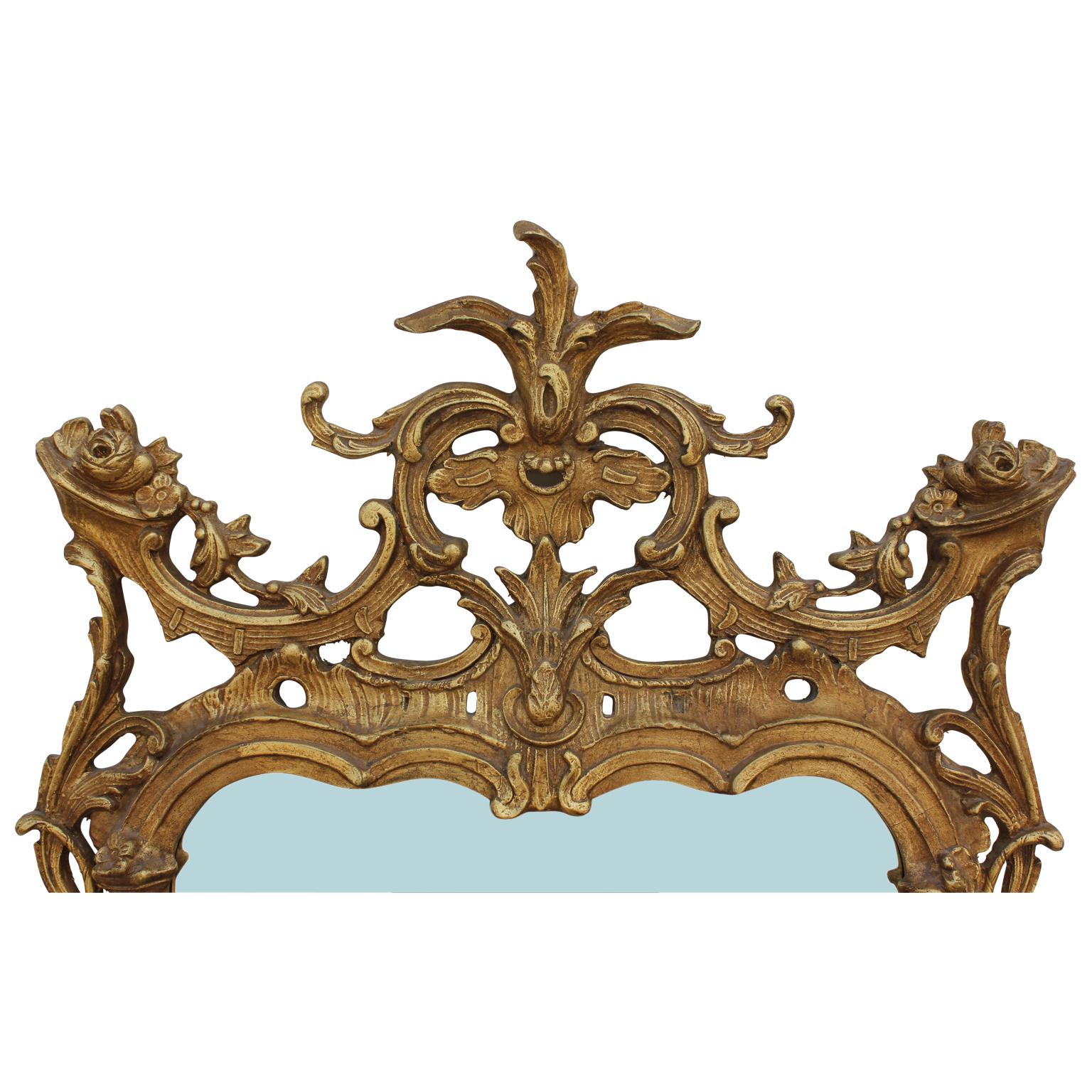 Chinese Chippendale or chinoiserie carved wall mirror circa 1940s. It is constructed of beautiful giltwood that still retains much of the original gold.