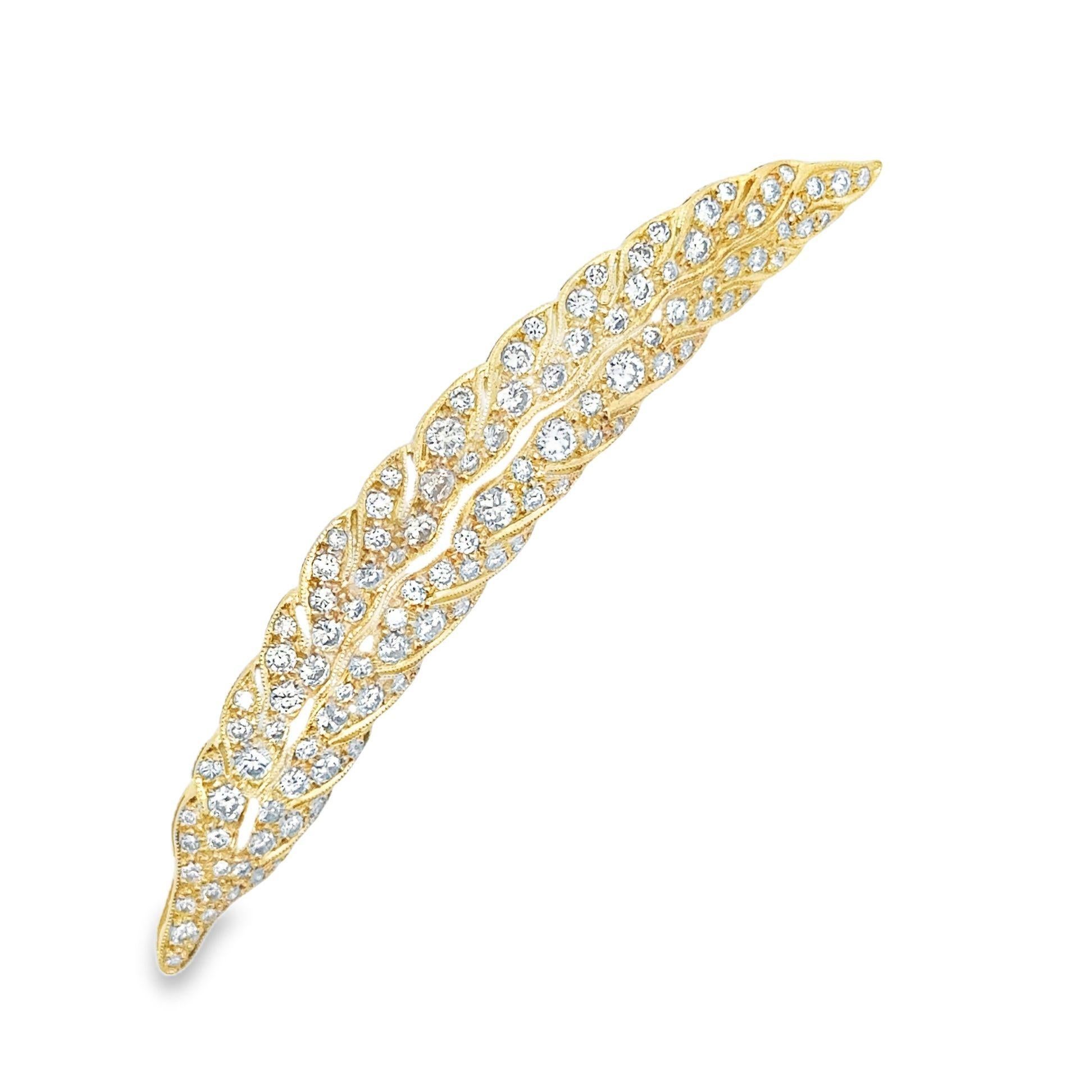 A lovely well-made piece of fine jewelry designed in the antique style. It features 2.32 carats of bright white round-cut diamonds set in an 18k gold detailed feather. The piece has movement and curves making the feather come to life. The settings